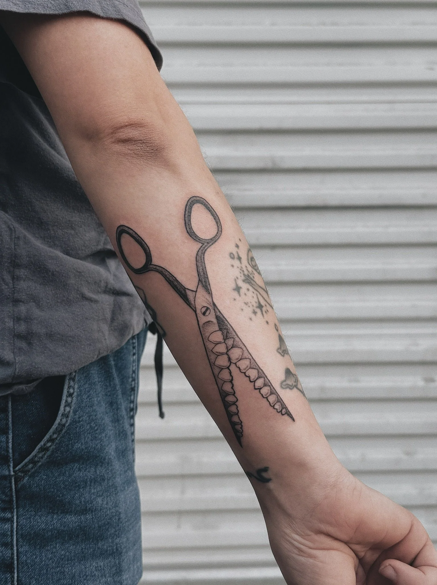 dotwork tattoo of scissors with teeth instead of blades