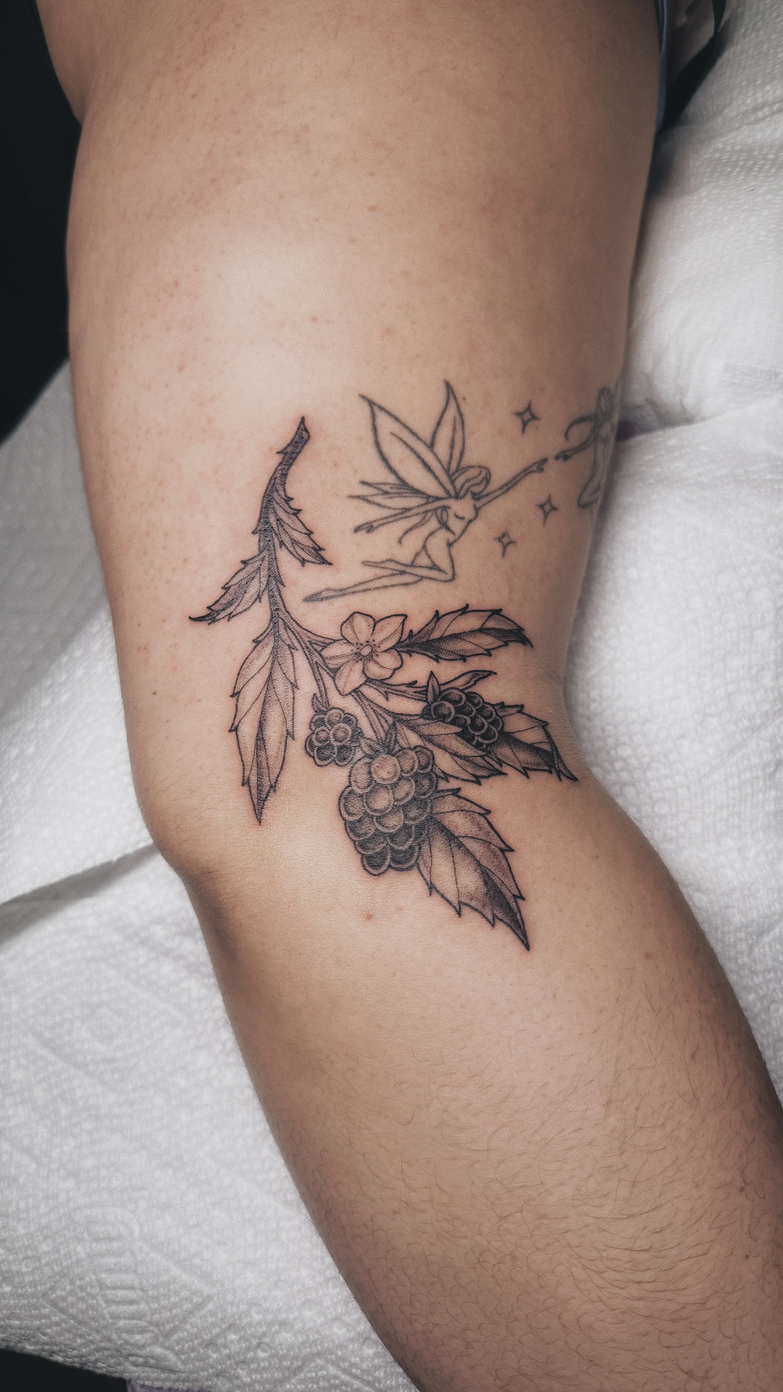 black and grey illustrative dotwork tattoo blackberry berry branch cluster  with leaves on elbow