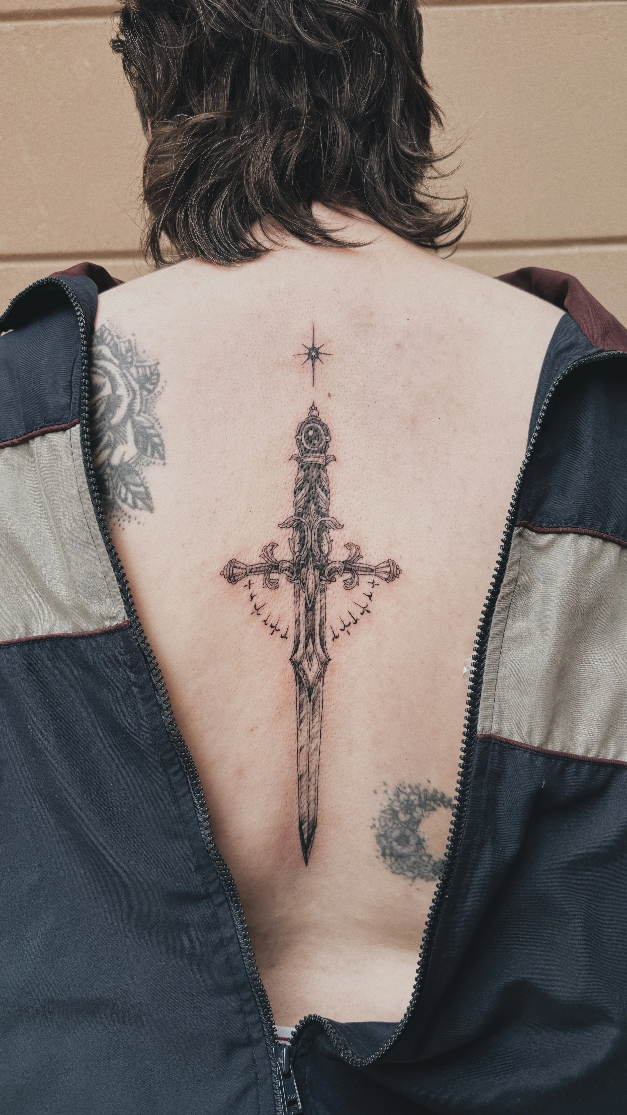 dotwork illustrative decorative sword with star and ornamental decor on a back