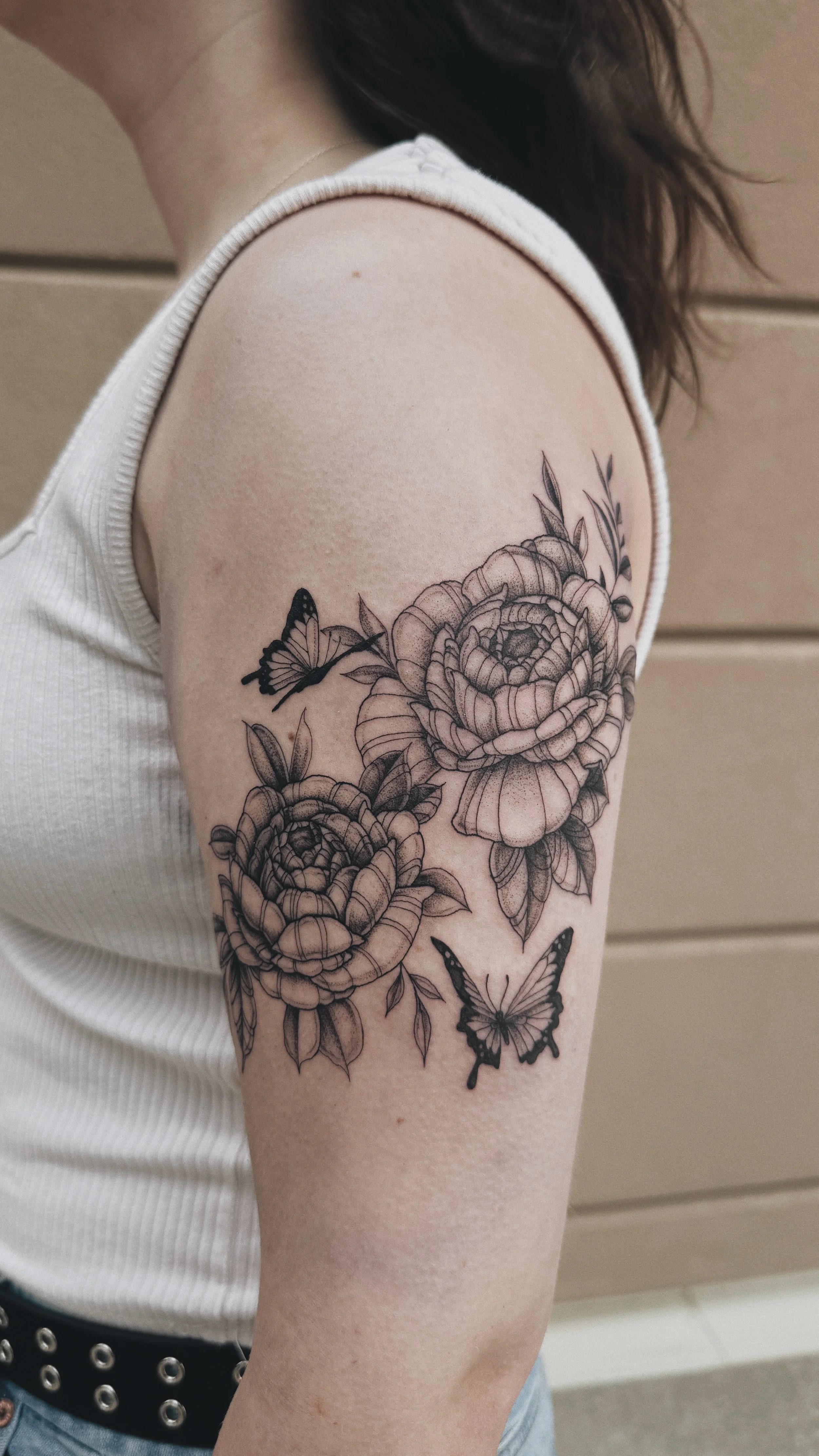 fineline illustrative peony floral tattoo with butterflies on the bicep