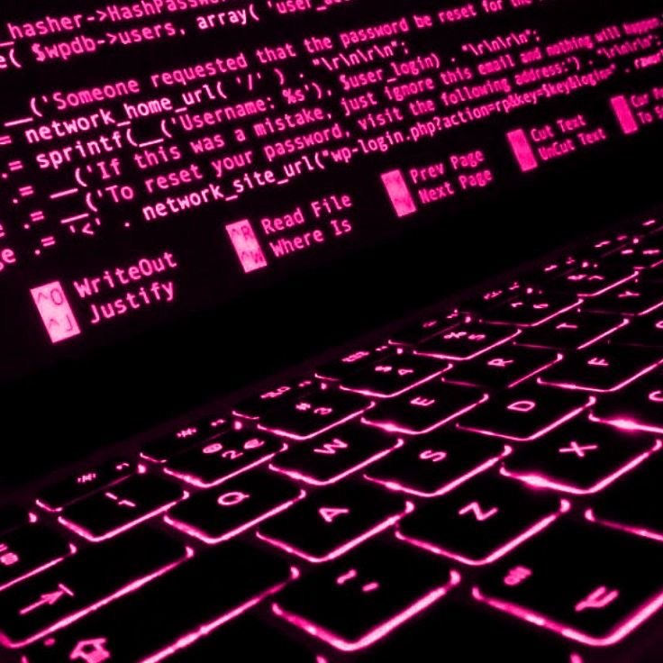 A laptop keyboard with pink backlight displaying code, with options for editing and file management.