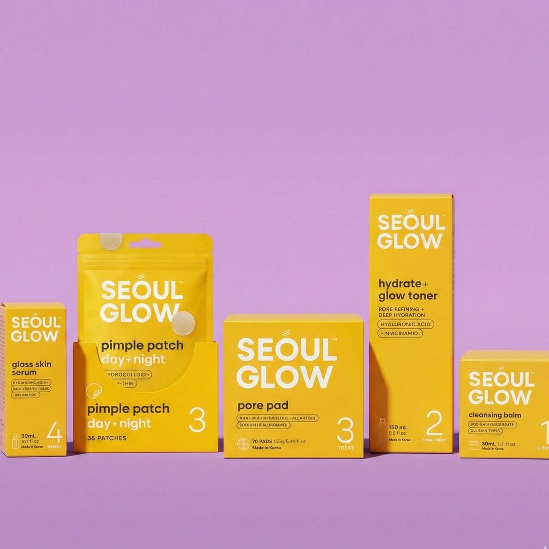 Collection of Seoul Glow skincare products on purple background, including pimple patch day and night, pore pad, hydrate and glow toner, and cleansing balm.