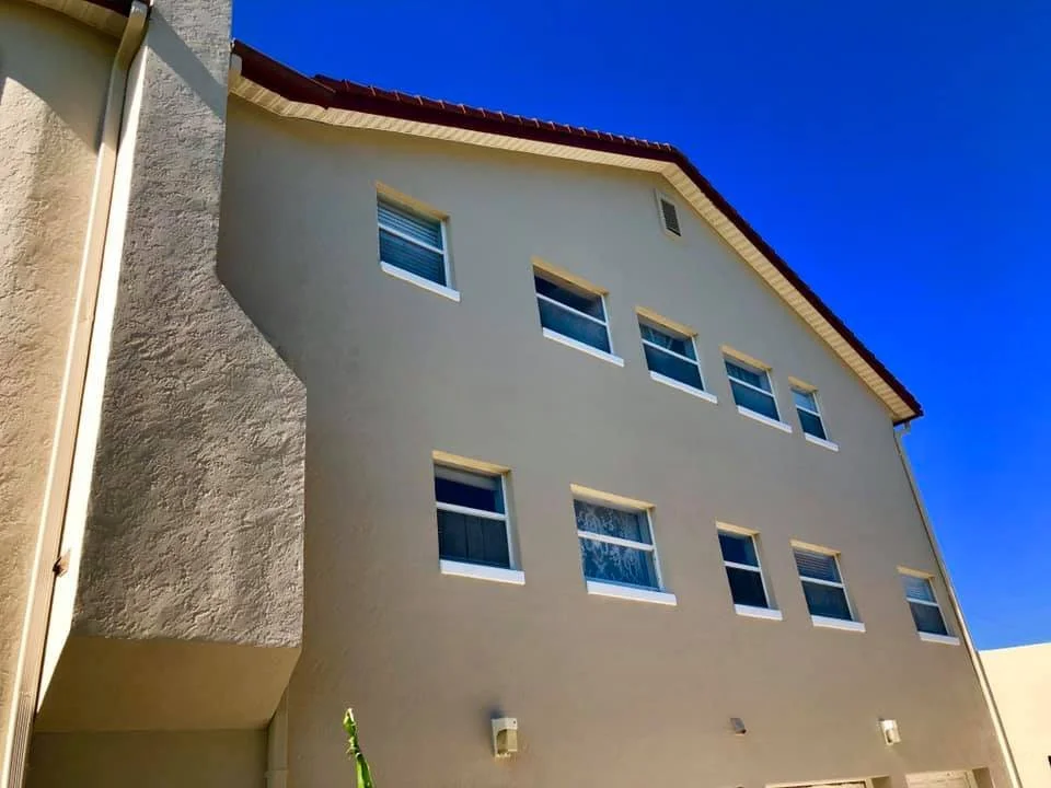 After: exterior wall repaint with even coverage and clean finish.