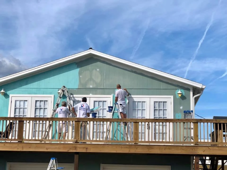 Painting crew photo after completing exterior house painting job.