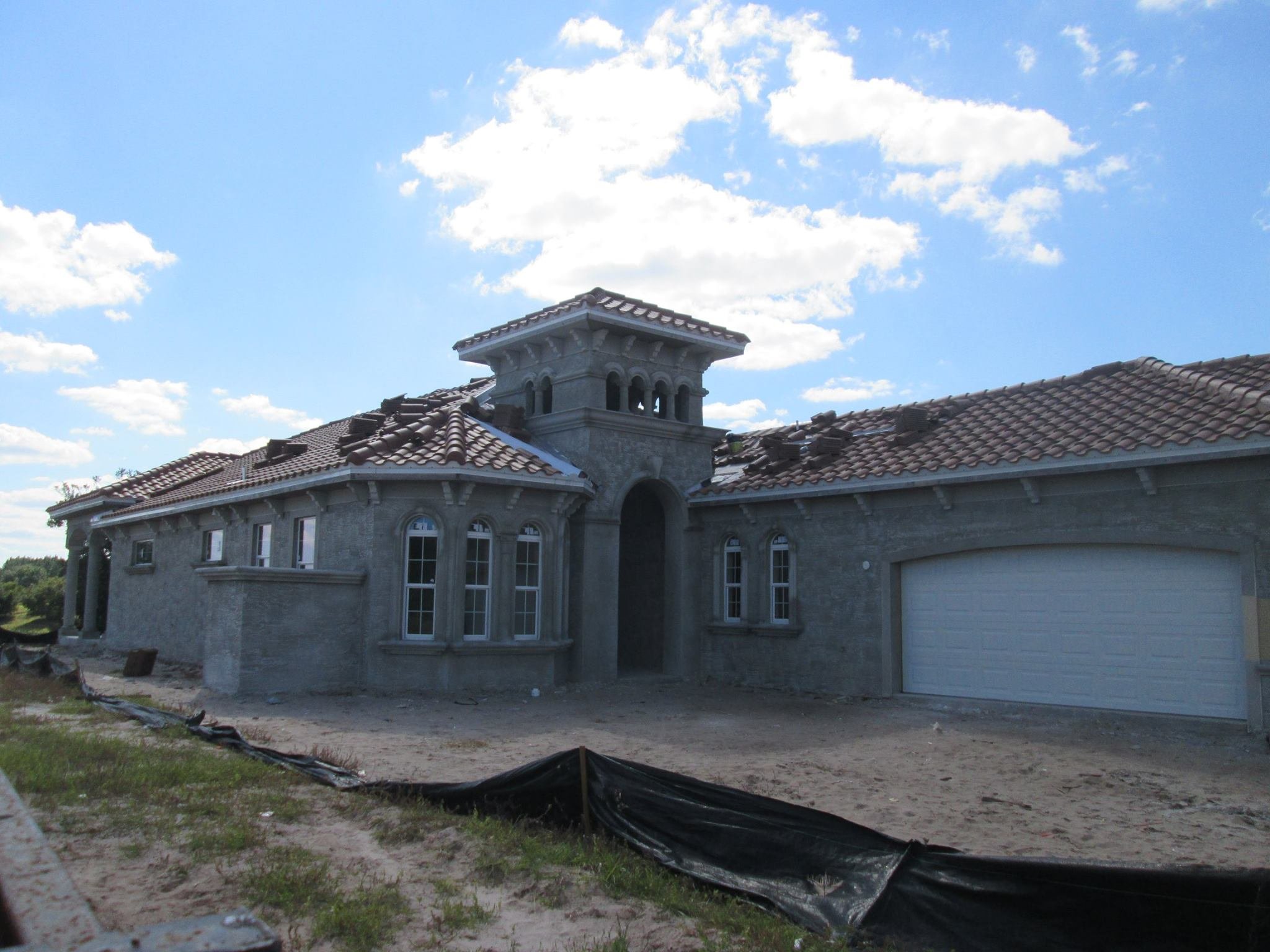 Before: Residential exterior repaint on Florida home with tile roof.
