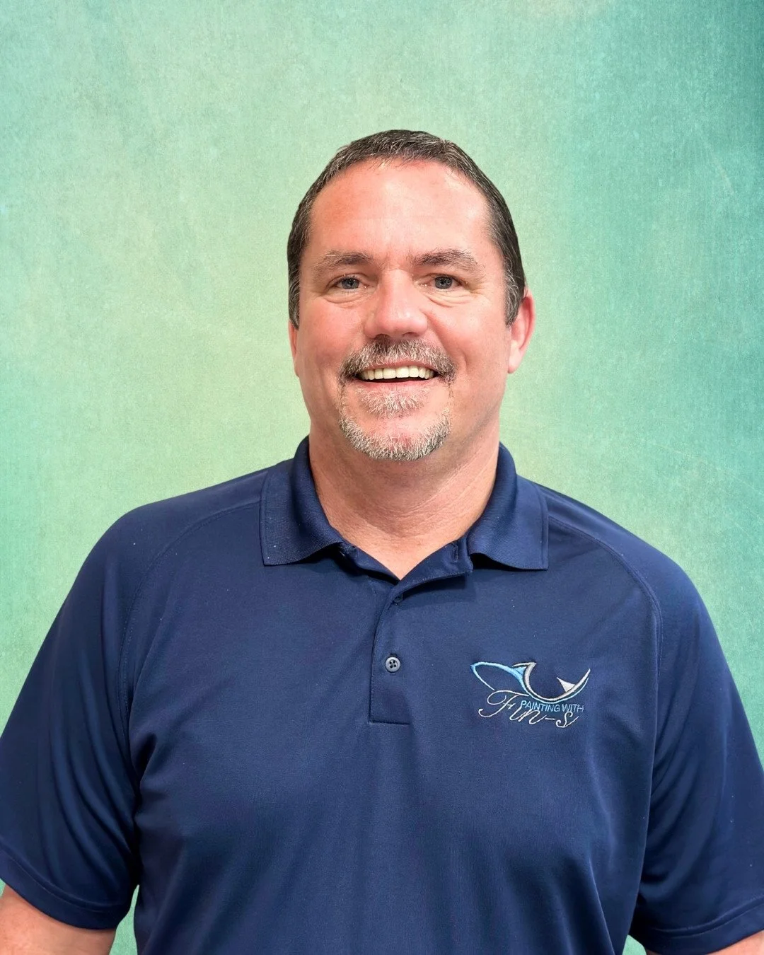 Business owner portrait in branded Painting with Fin-S polo shirt.