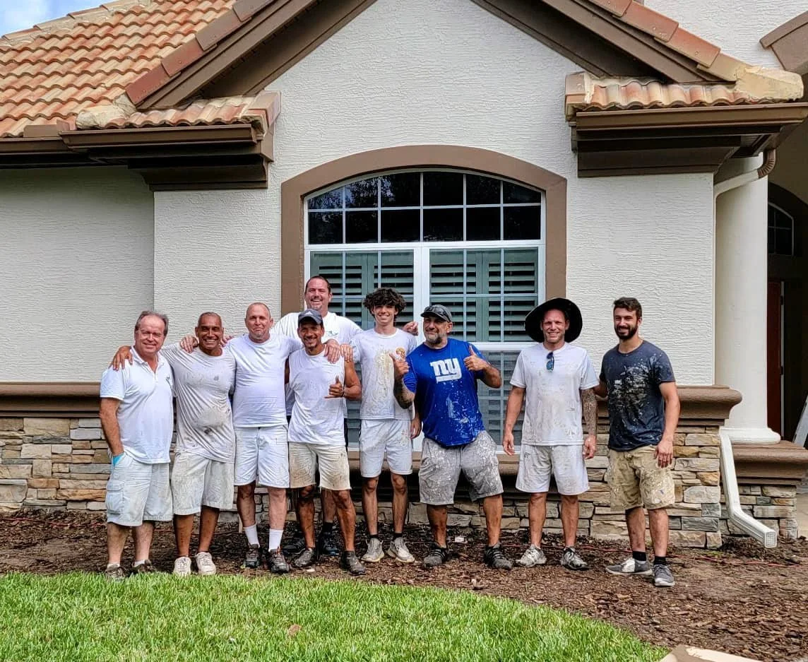 Painting crew photo after completing exterior house painting job.
