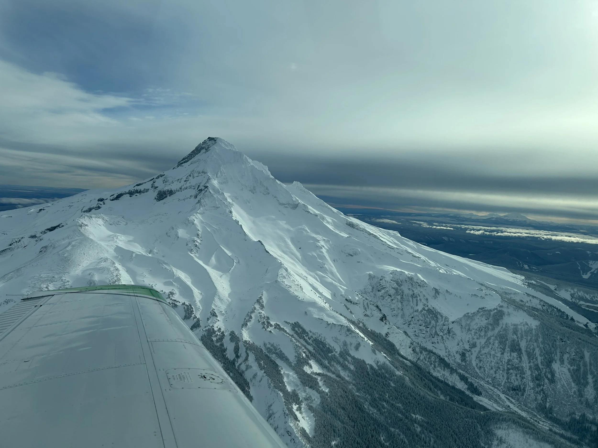 Aircraft wing and strut over landscape during pilot training flight near Bend, Oregon