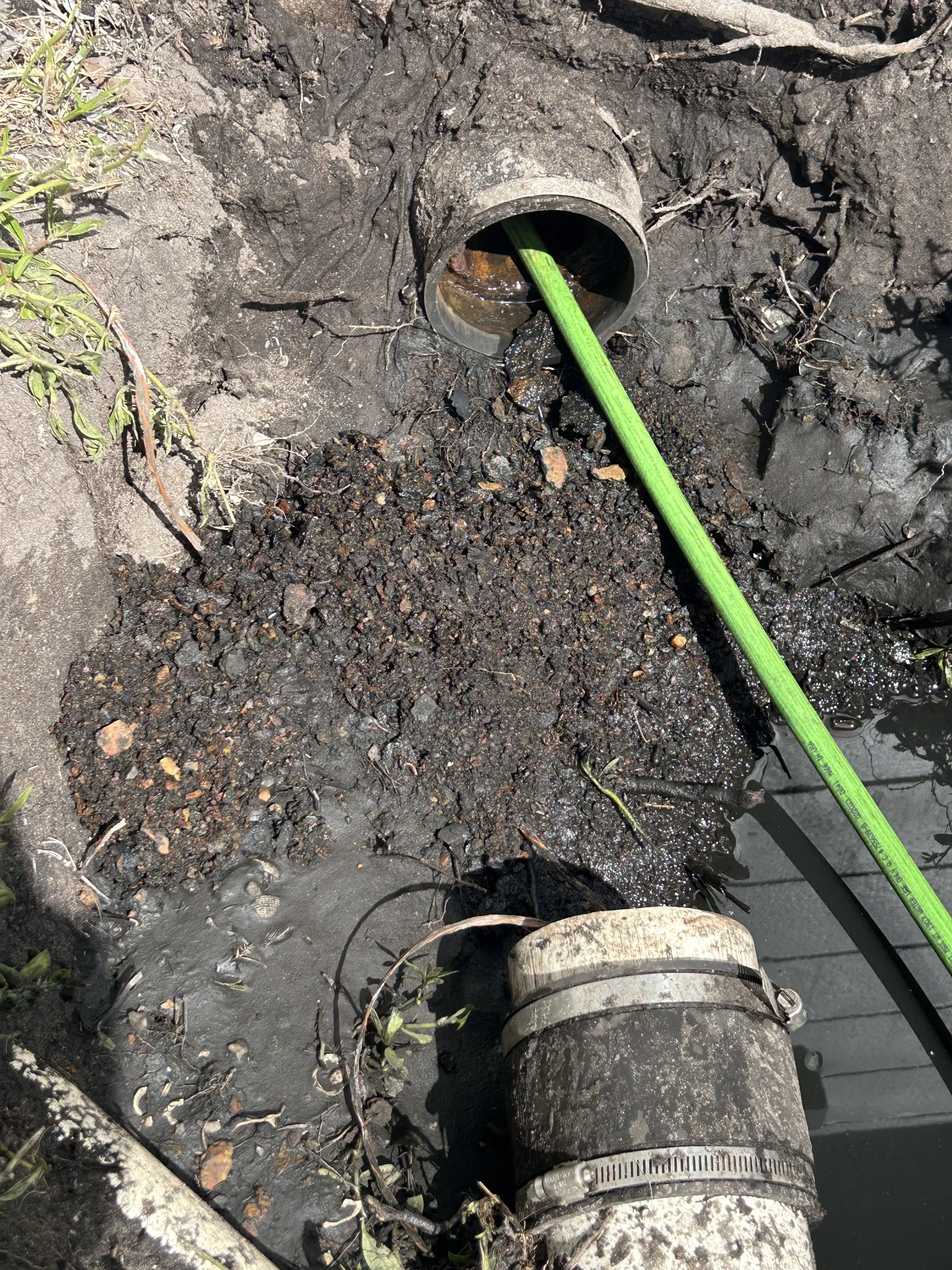 image showing cast iron restoration with hydrojetting, image shows lots of cast iron scale build up that was removed from the pipe. this allows the pipe to drain properly and prevent stoppages, clogs, or backups for toilets sinks and showers or drain