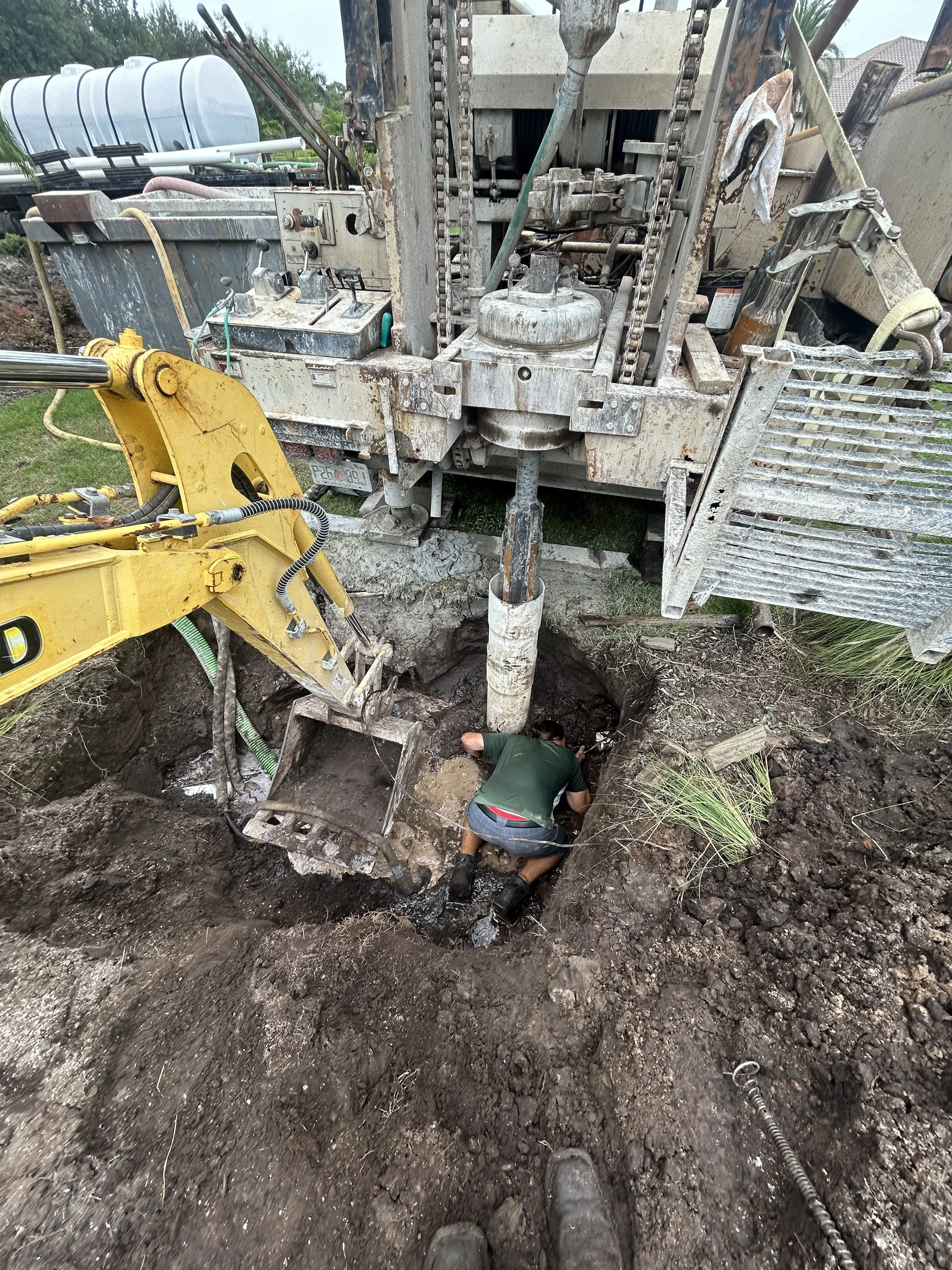 Removing dried cement from the inside of a pipe that was hit by well drilling rig.