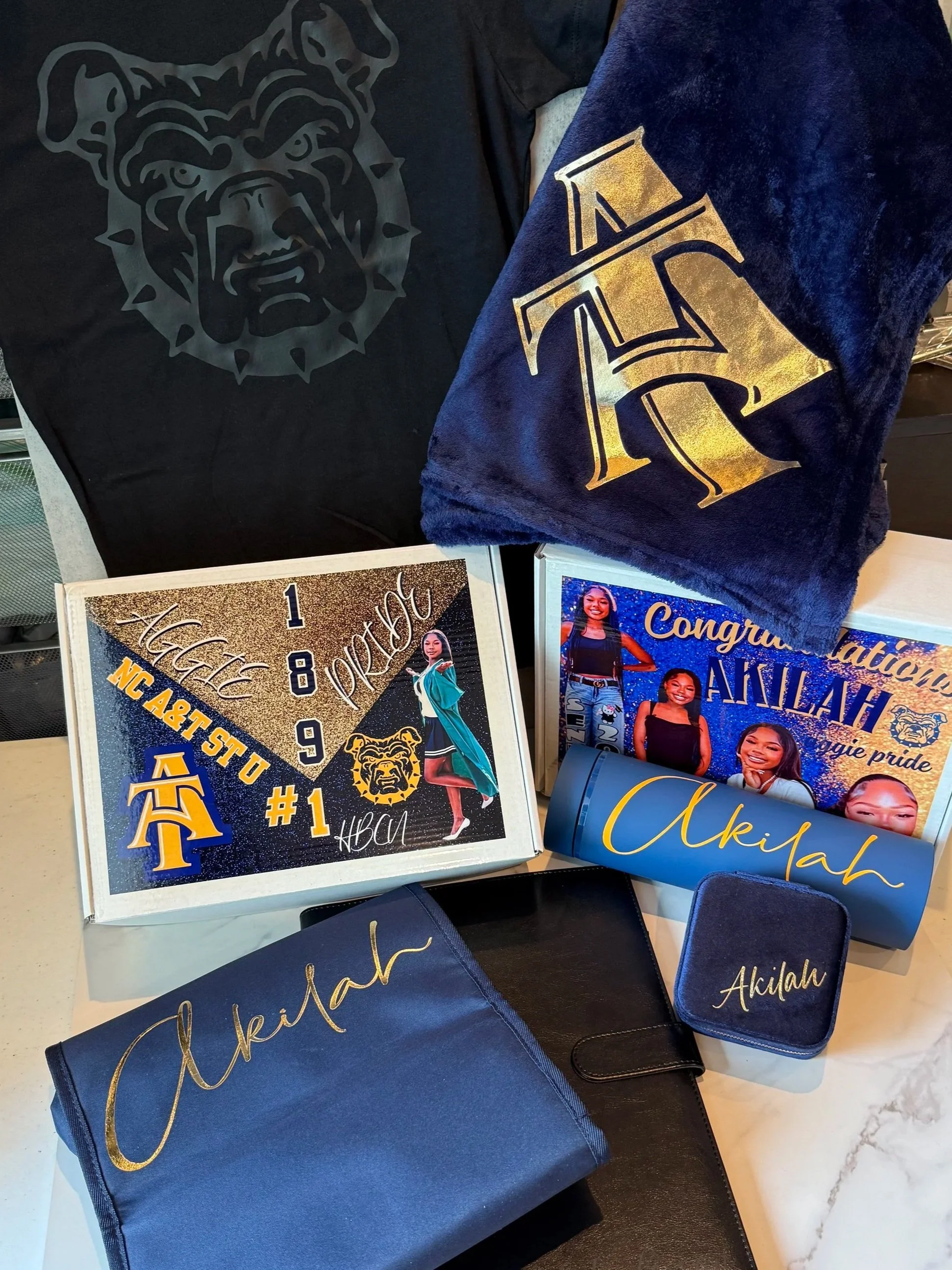 A College Decision Gift Box is a customized, ready-to-gift set made to celebrate the student’s big next step in a fun, practical way. Each item is personalized with the student’s name, school colors, class year, and the college they’re committed to—m