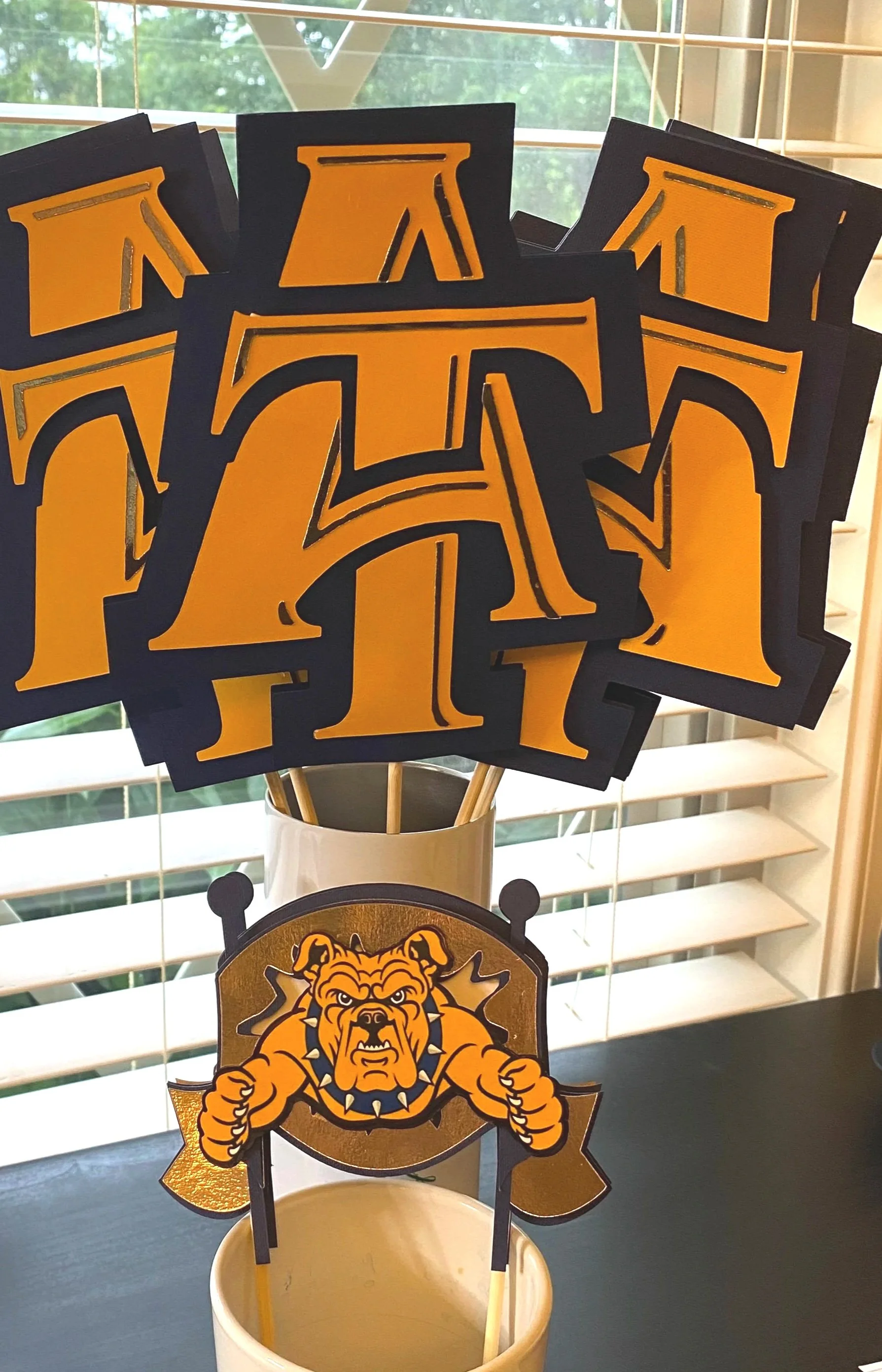 Graduation Party Table Decor- Custom table décor adds the “wow” factor to your setup by tying your theme together with coordinated, personalized details. From centerpiece sticks to tabletop accents, each piece is designed to match your colors, graphi