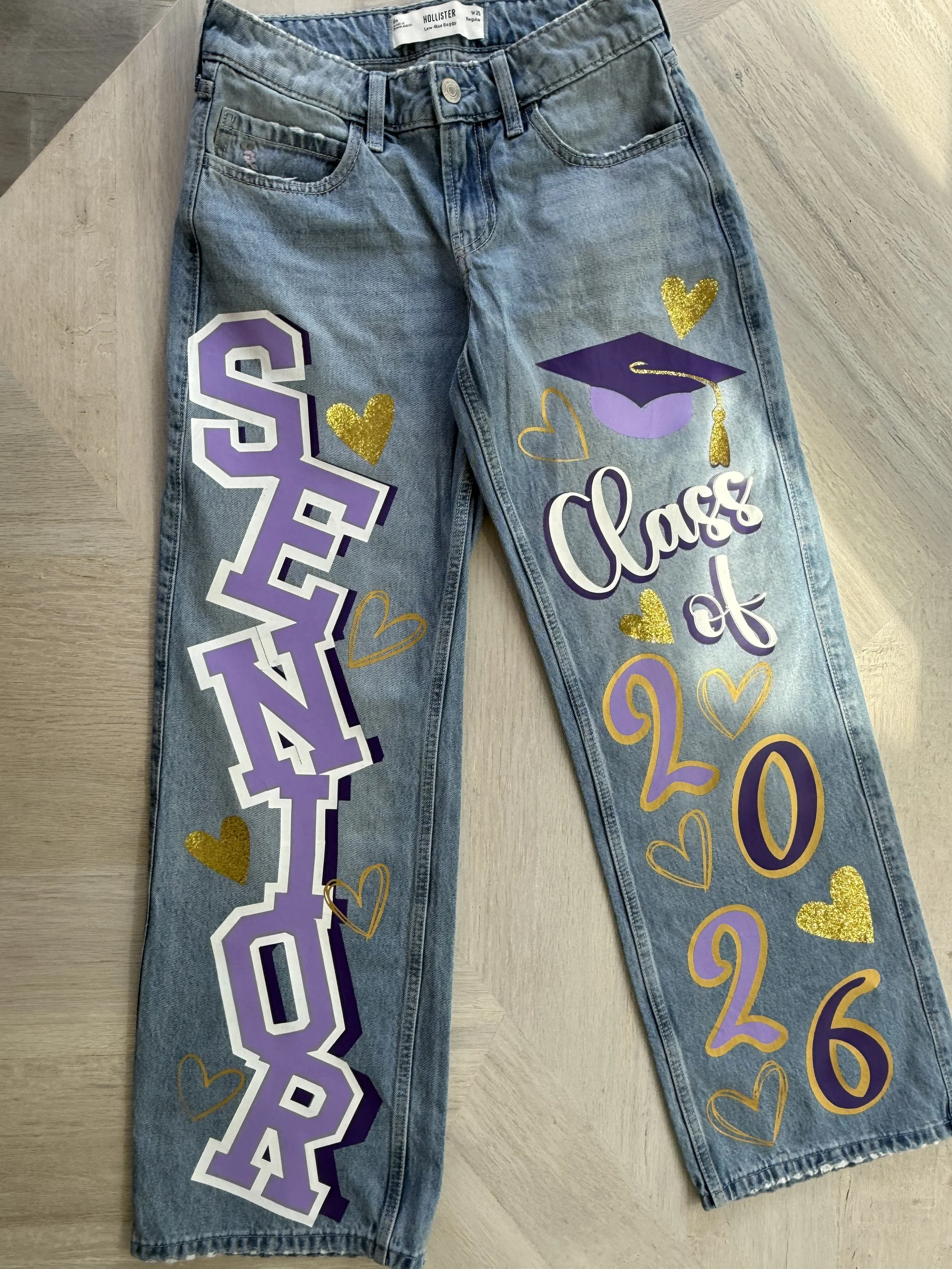 Celebrating the Graduate-Senior Jeans- Celebrate your senior’s big year with custom apparel designed to honor their achievements and upcoming graduation. From shirts and sweatshirts to personalized designs featuring names, photos, school colors, and 