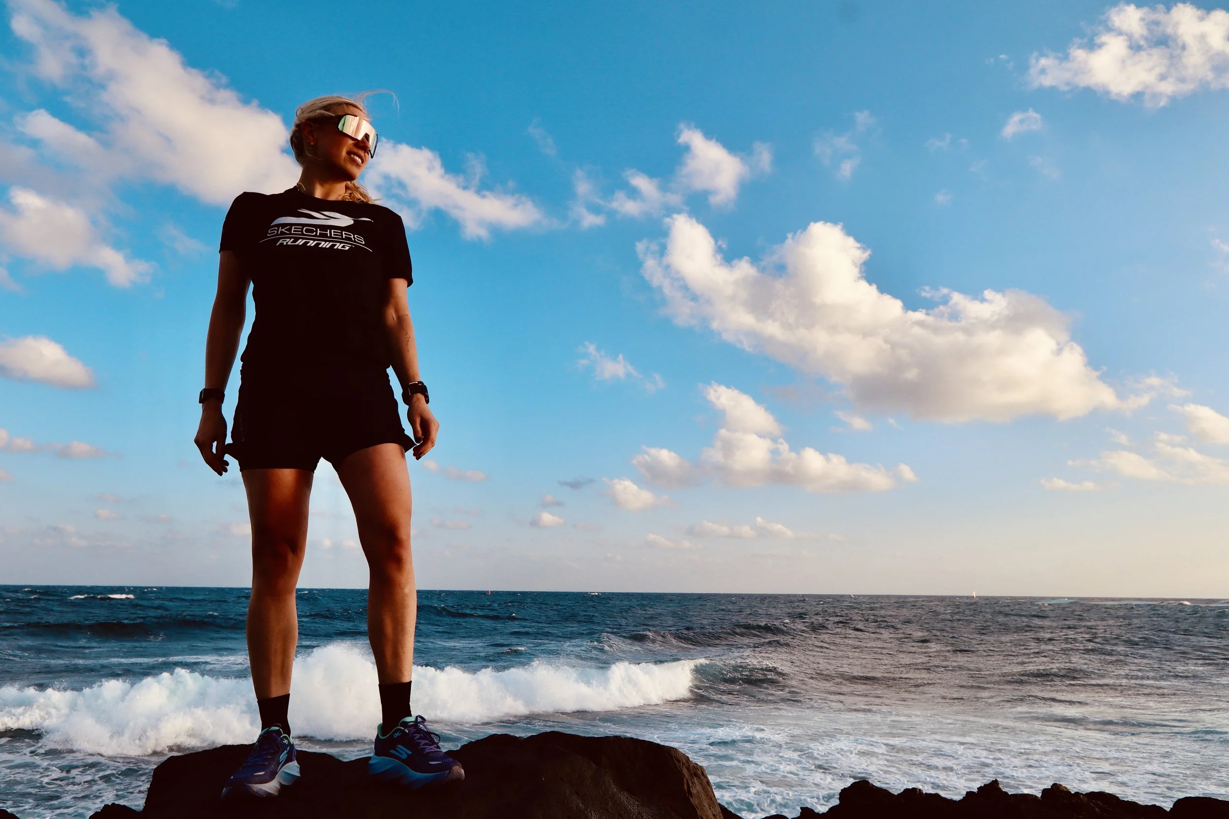 A woman wearing Skechers on the beach