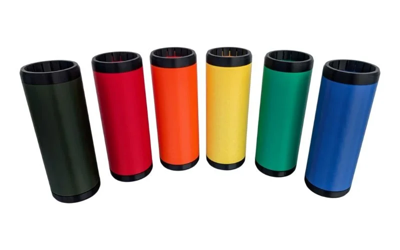 Six colorful reusable travel mugs standing in a row, from left to right: dark green, red, orange, yellow, green, and blue, against a white background.