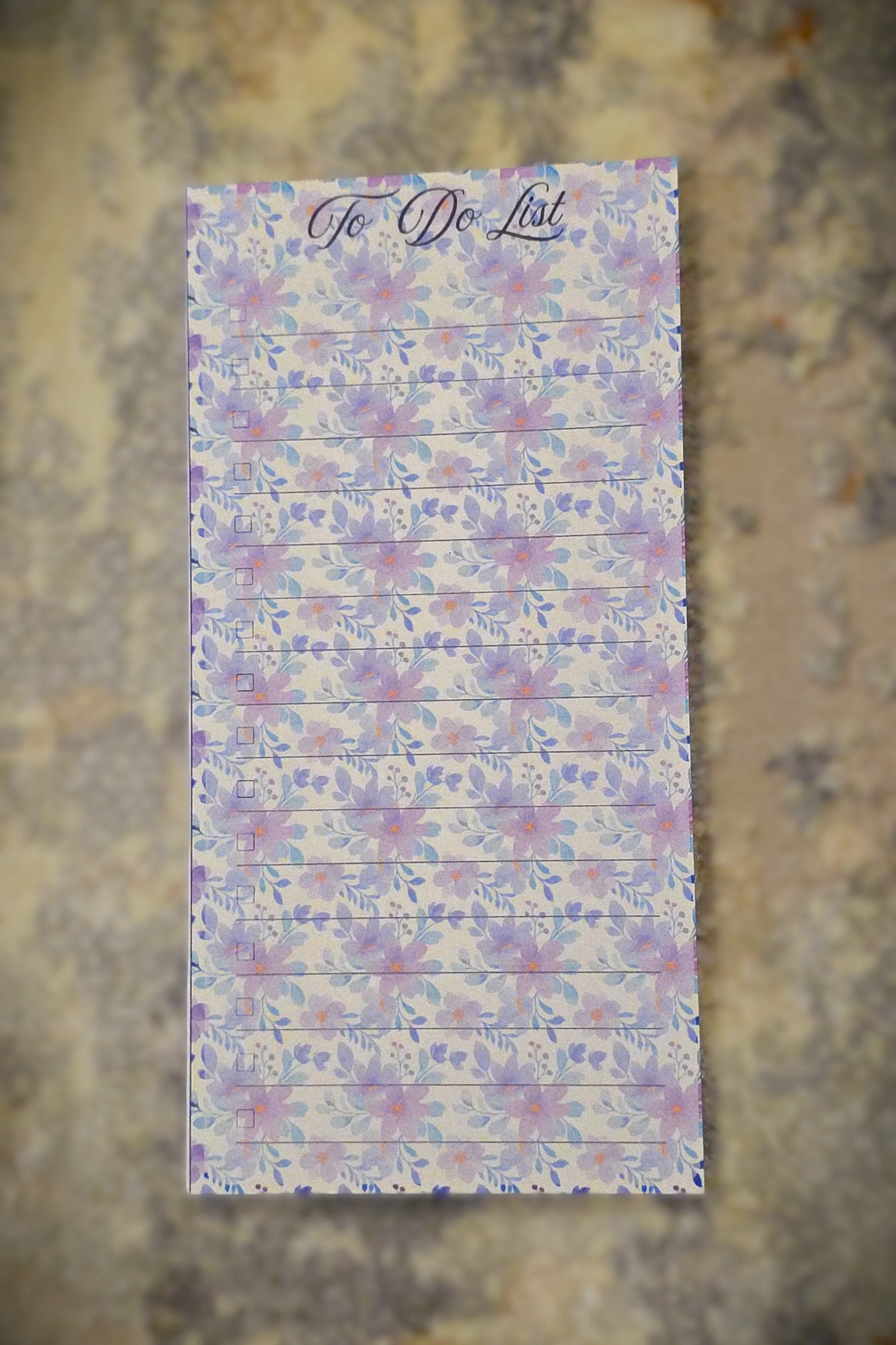 A floral-themed to-do list pad with lavender and purple flowers, titled "To Do List" at the top.