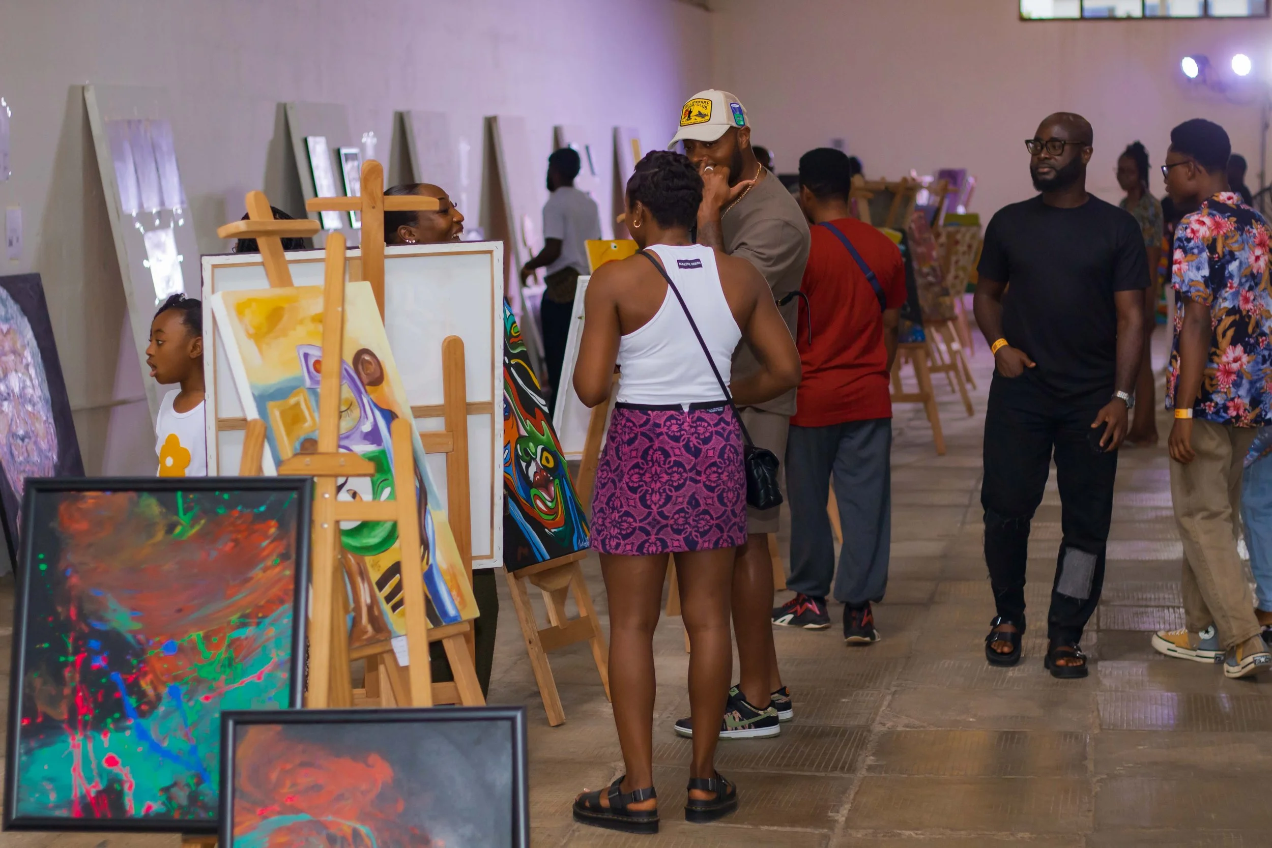 People browsing and observing artwork at an art gallery or exhibition.