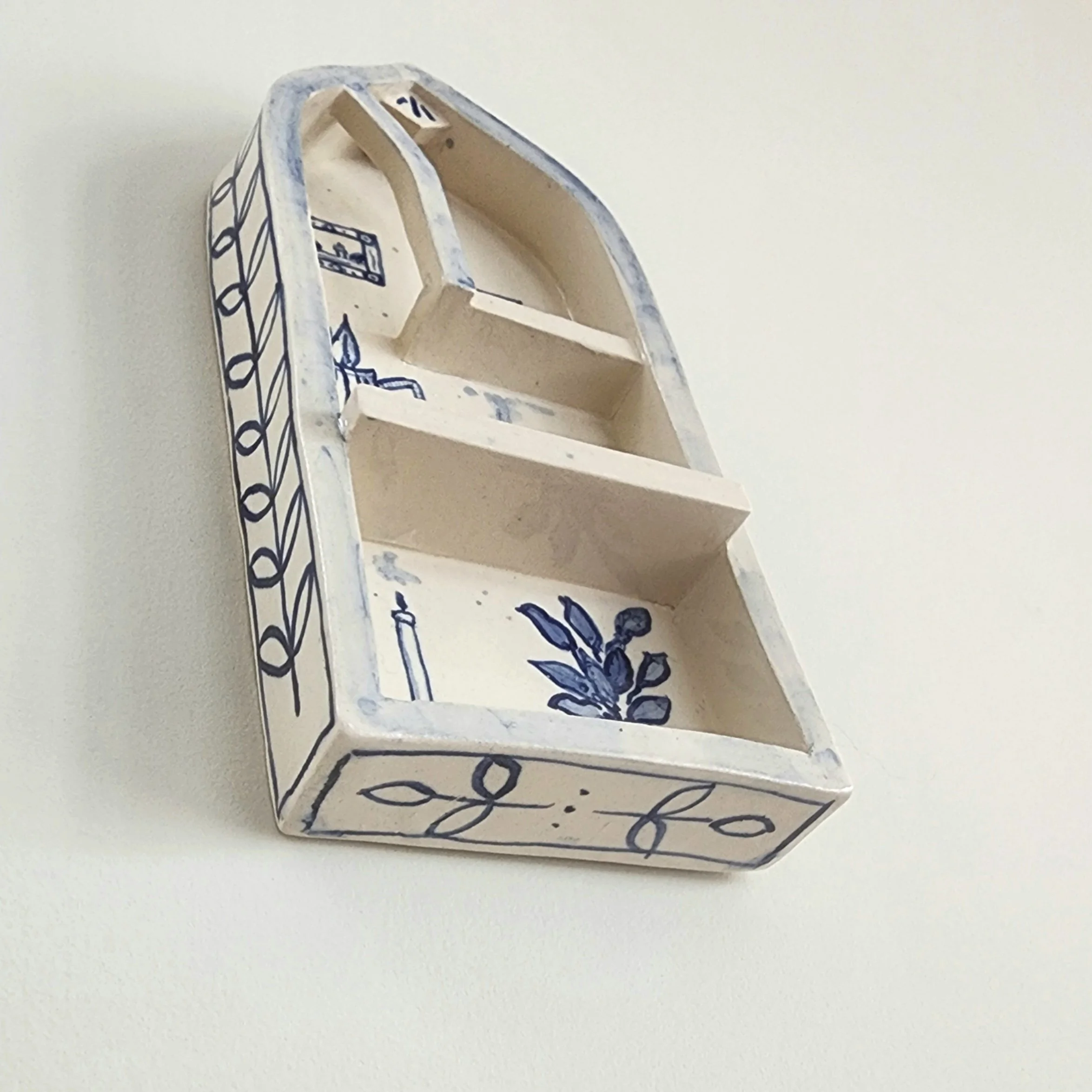 One-off wall hung shrine in stoneware. Hand painted and then glazed. Hangs on a nail. 

The illustrations are inspired by the comforts of a home that is safe and cocooning. 

Can be used to display small trinket, or just hang as is. 

Measurements:
H