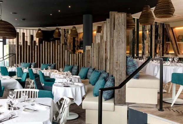 Intérieur du restaurant ou bar lounge de l’Hôtel Les Bains d’Arguin, avec un design moderne et des tables pour les événements de groupe.