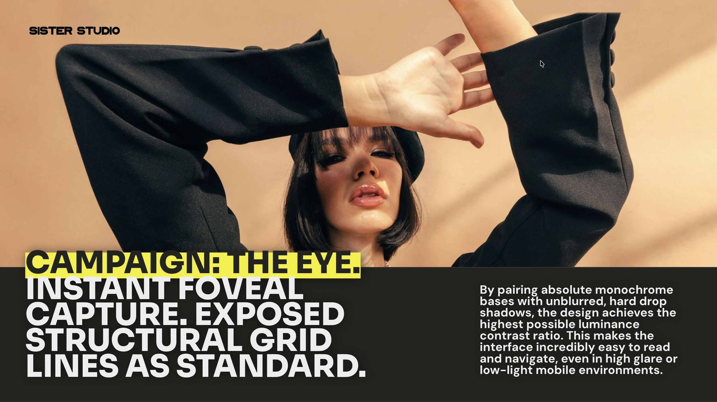 Image of a woman with short dark hair and bangs, wearing a black outfit, making a gesture with her hand near her eye, with a plain beige background.