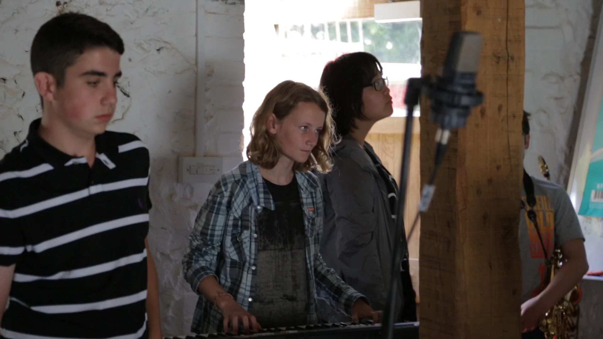 students play keyboards in a music workshop