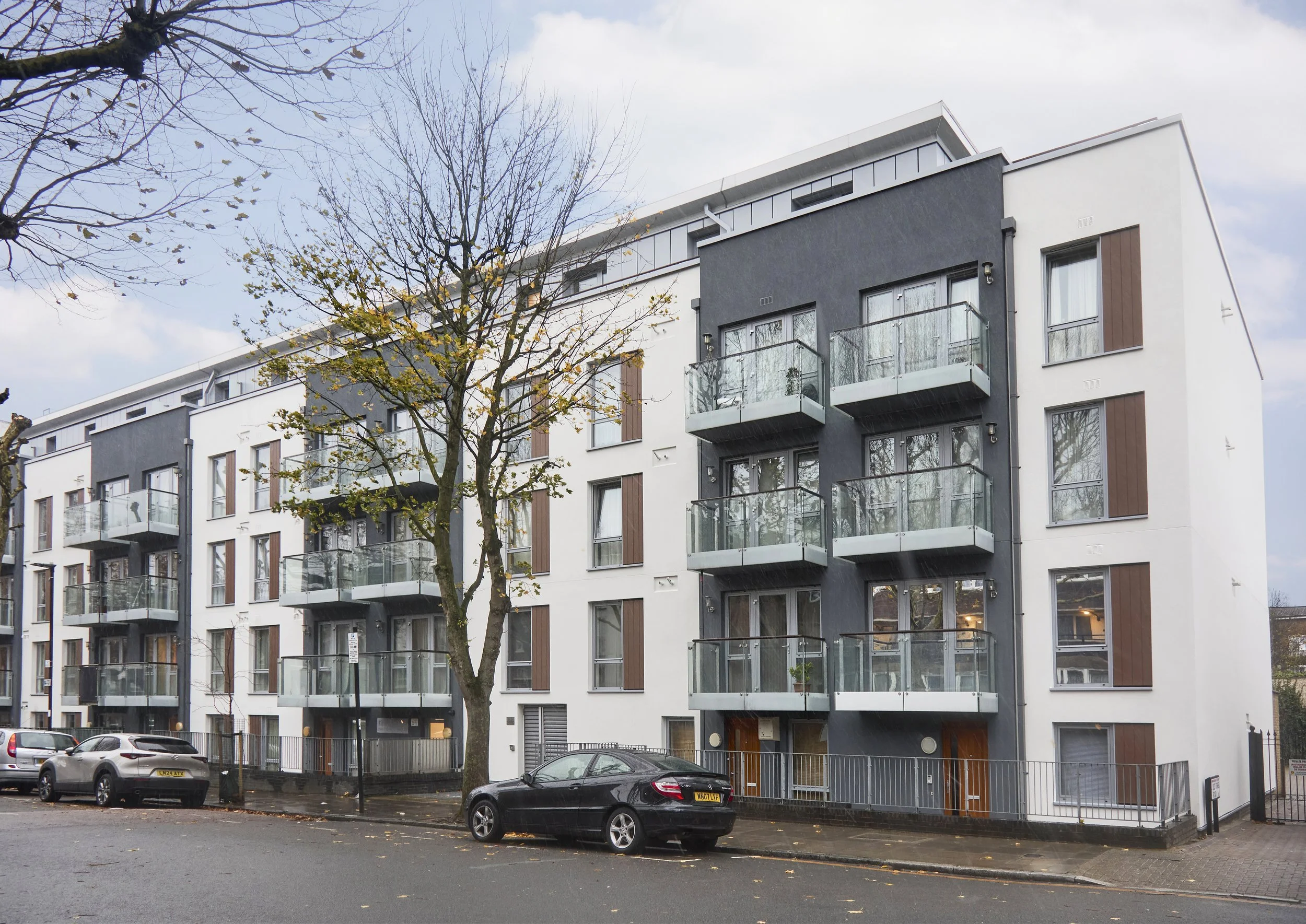 Kinver House, Islington. A modern apartment building with glass balconies following cladding remediation works, carried out by Archway Facade Management.