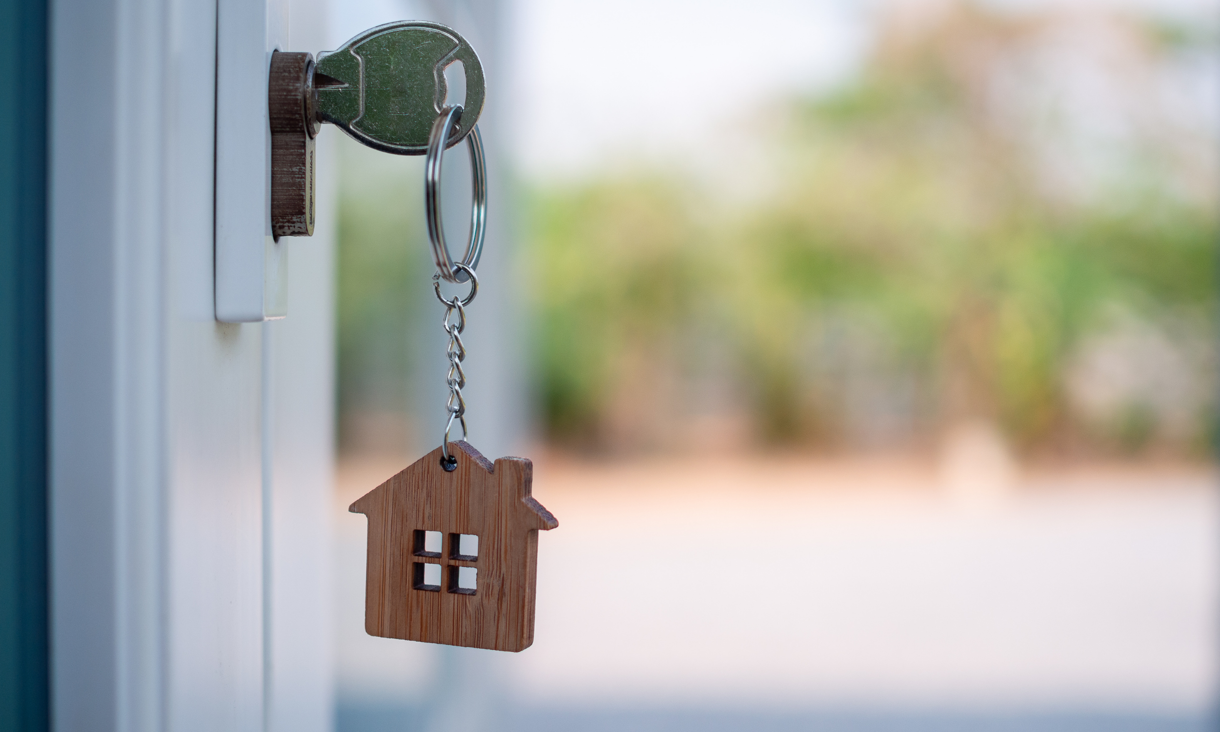 Key in a door, representing a sold home.