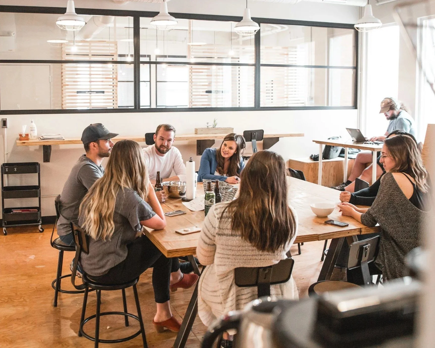 team of people sat around table in meeting