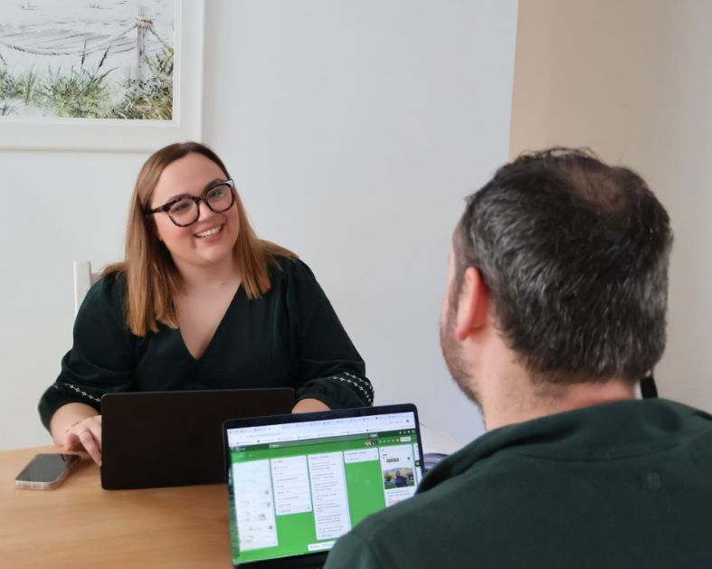 Marketing Collab founder Lauren sat at table meeting a client