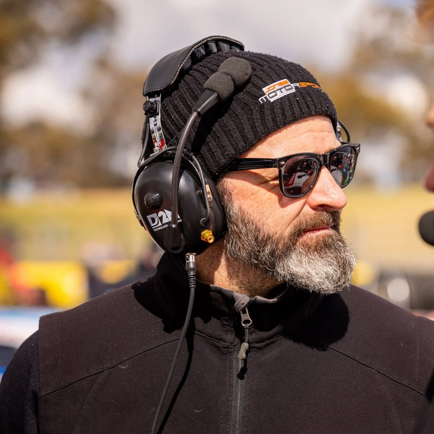 Rheb Brodie with a headset on at the race track