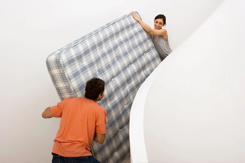 Deux personnes déménagent un matelas