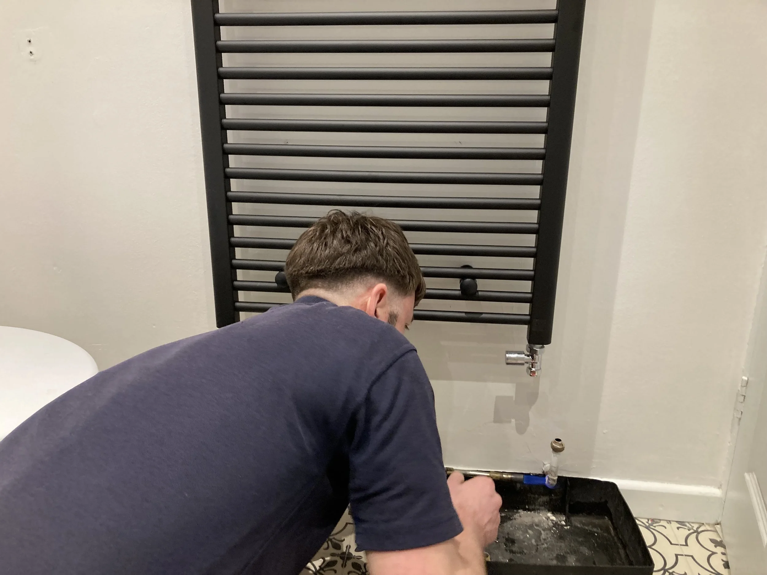 Heating Engineer Installing Radiator
