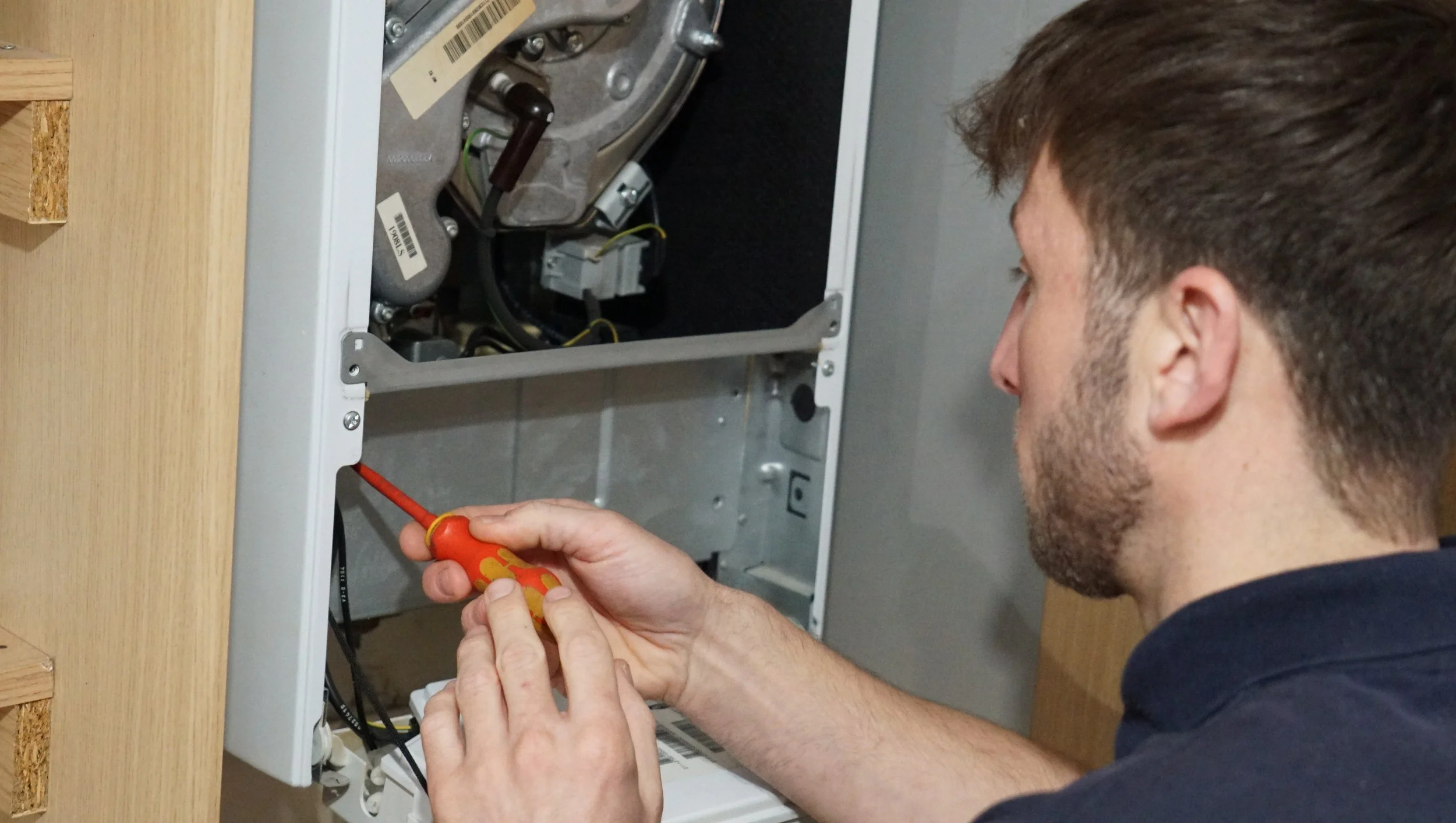 Fixing a boiler in a cabinet. Boiler servicing.