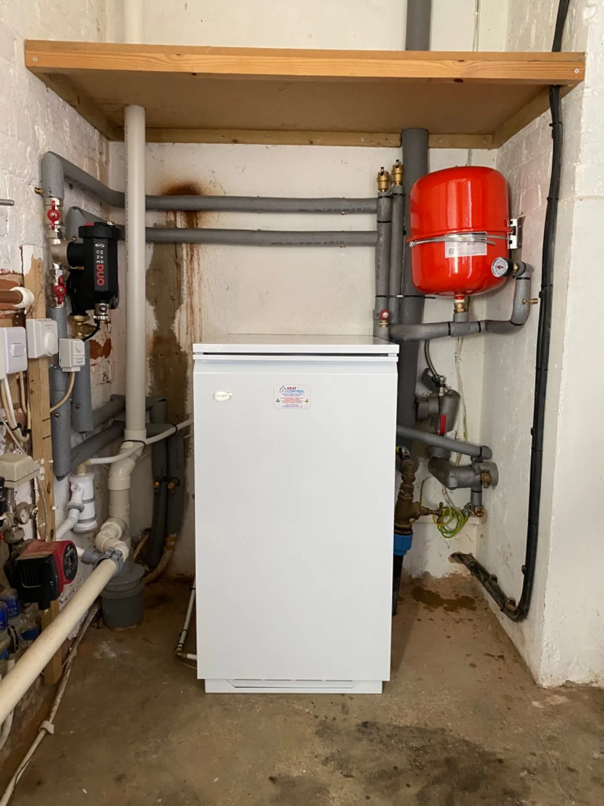 A new installed boiler in a utility room.