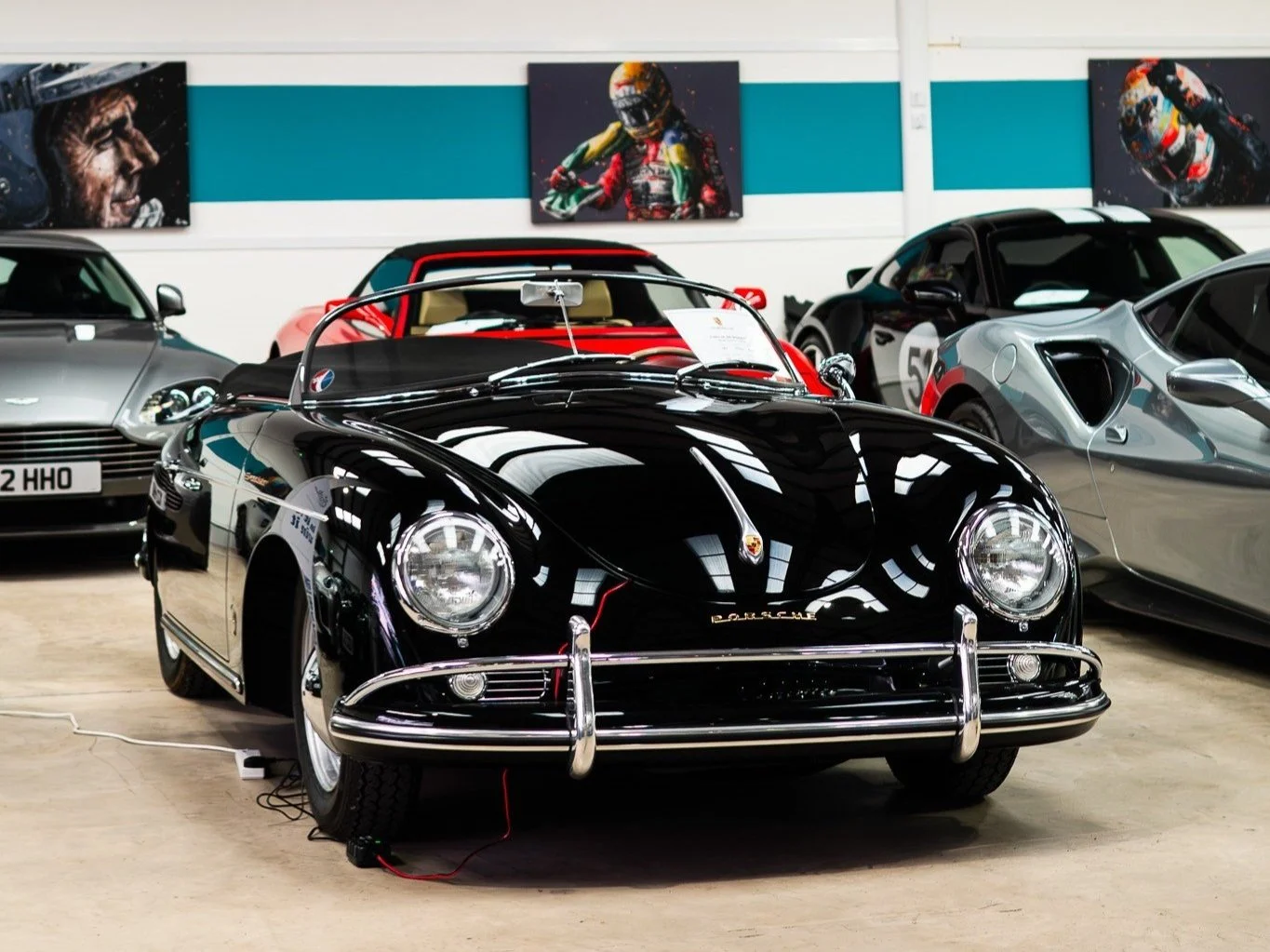 Black vintage Porsche sports car on display at a car showroom.