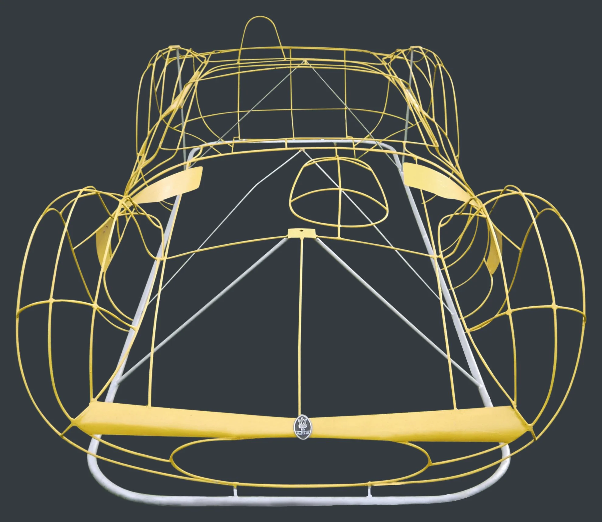 Yellow metal structure of a trampoline with a curved framework and safety enclosures on a dark background.