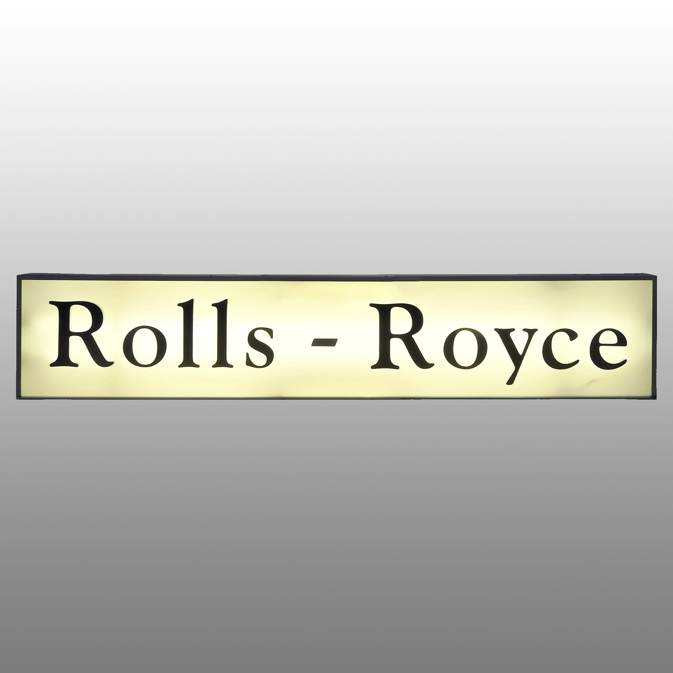 Lighted sign with the text 'Rolls - Royce' on a white background.