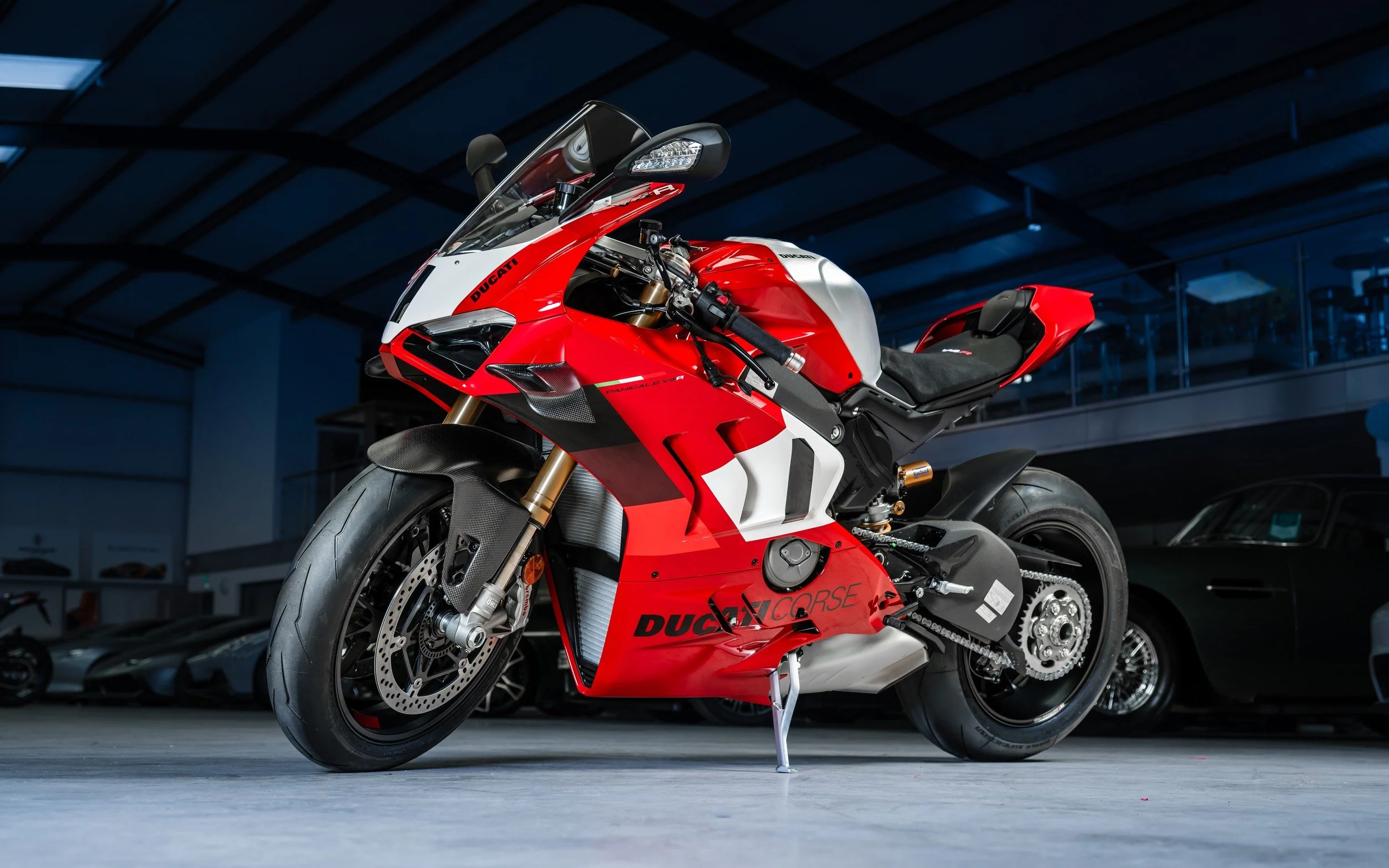 Red and white Ducati motorcycle in a showroom.