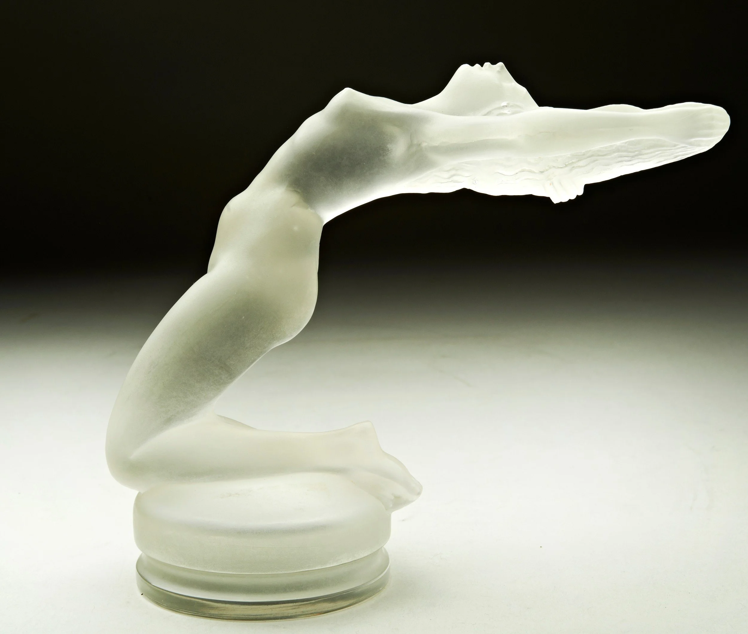 An abstract glass sculpture resembling a whale.