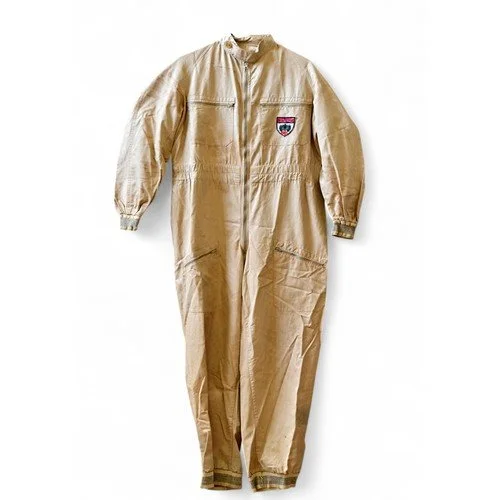 Beige jumpsuit with a patch on the chest and elastic cuffs.