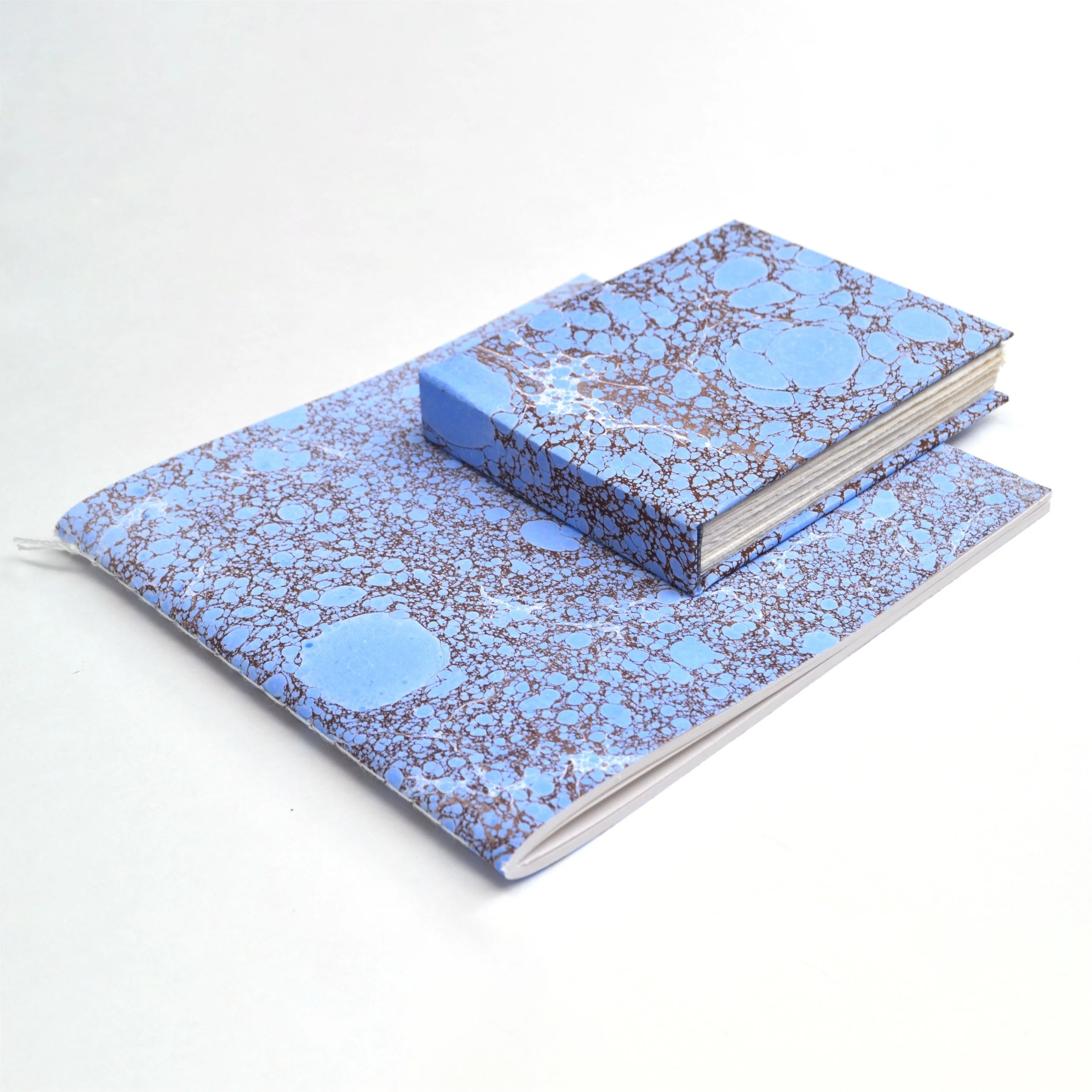 Bōk Bindery

Samsam Petherbridge has hand-bound and marbled many books under the name Bōk Bindery. This process has led to many collaborations and projects. Here are some of his favourites