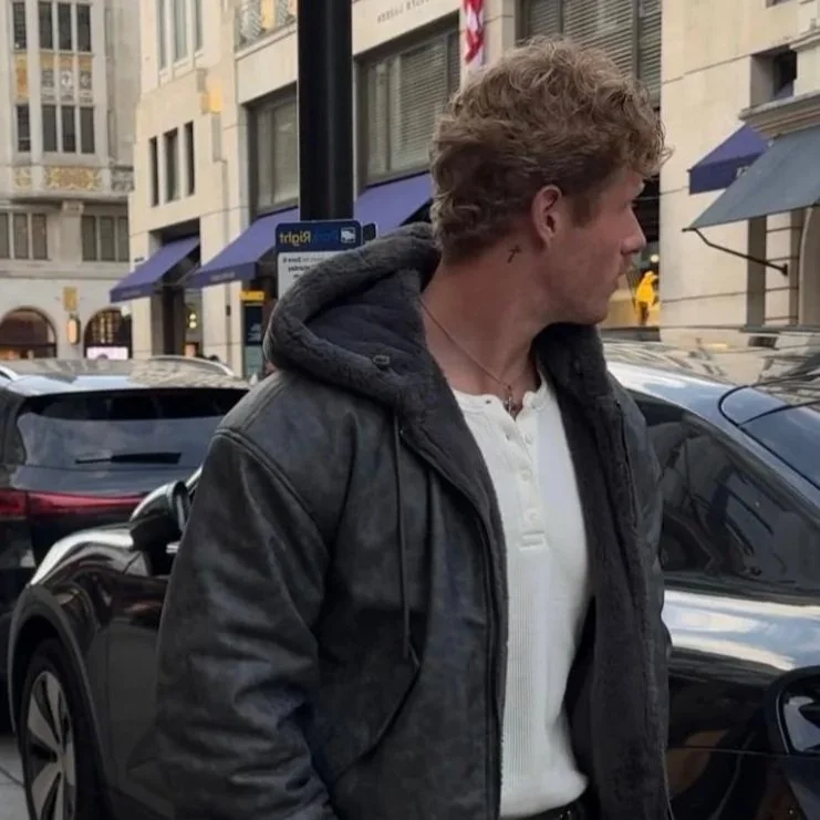 Image of Dan Hayes looking away from the camera in a street with cars in the background