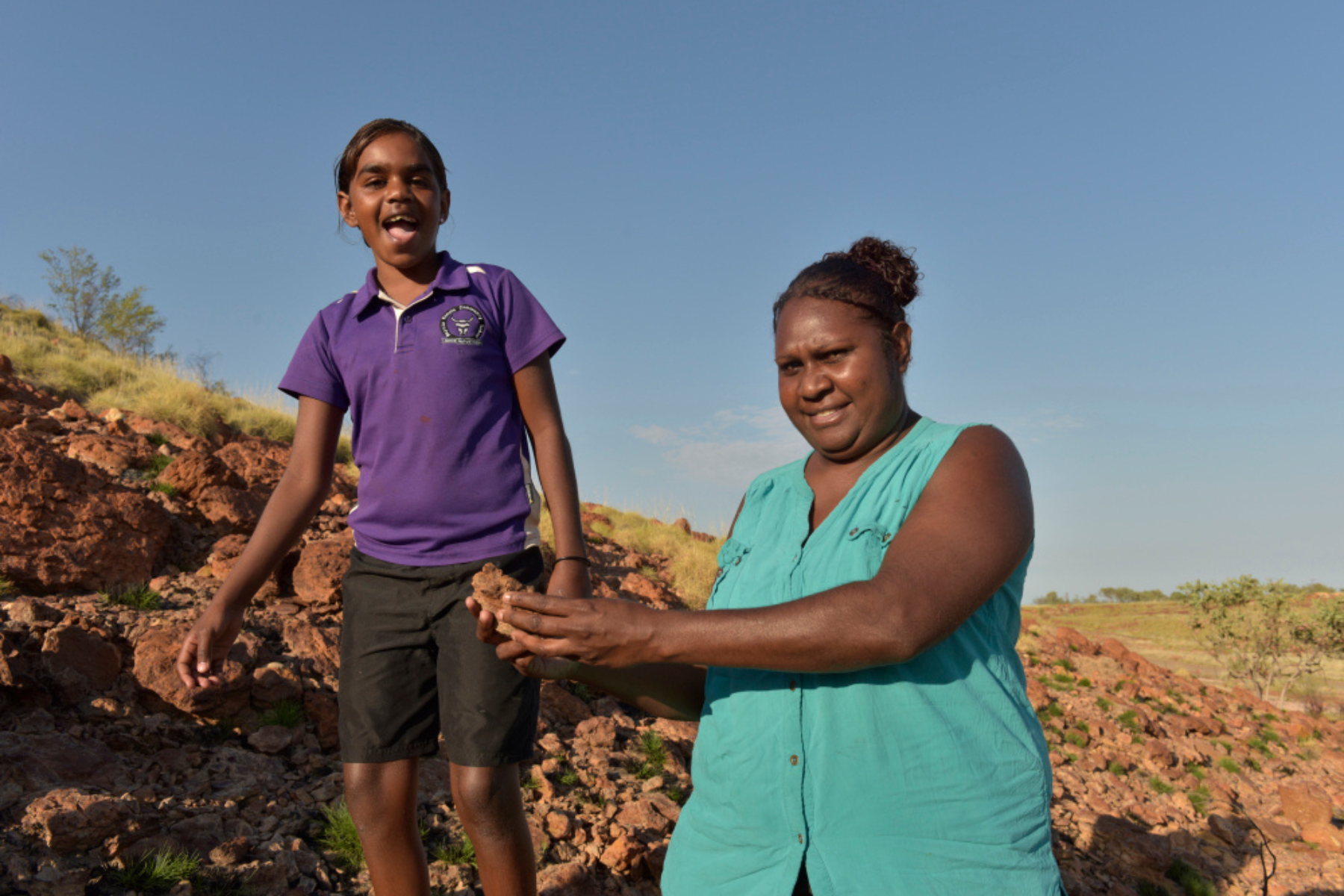 Indigenous mother and duaghter on country, smiling and happy
