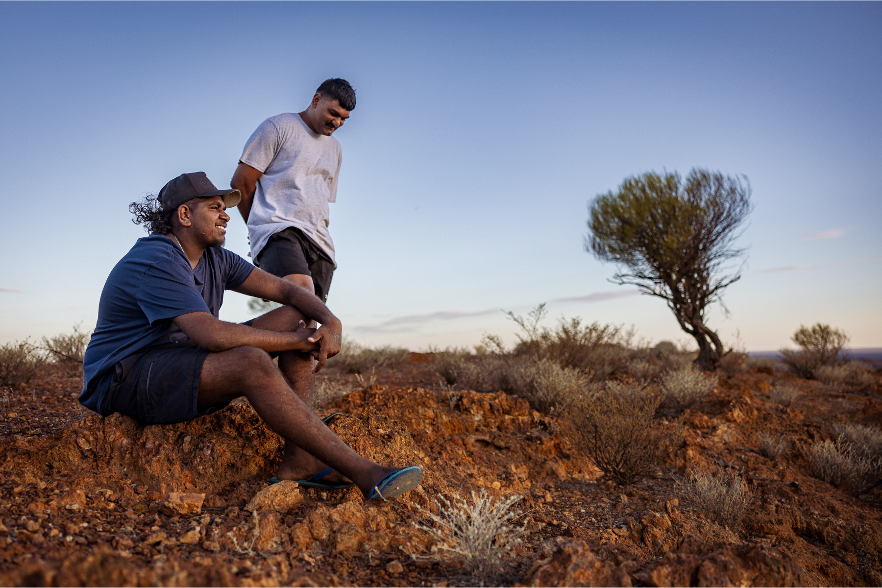 Young indigenous men on country, one an NDIS participant the other a Haven Home & Support Services worker