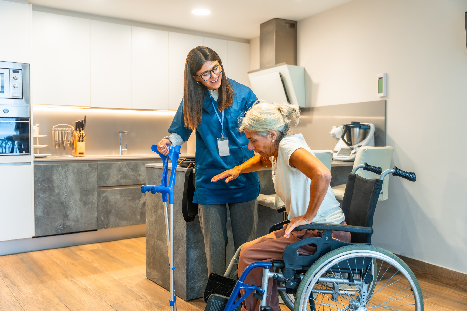 Haven Home & Support Services helping an elderly woman transfer out of her wheelchair in her North Brisbane home