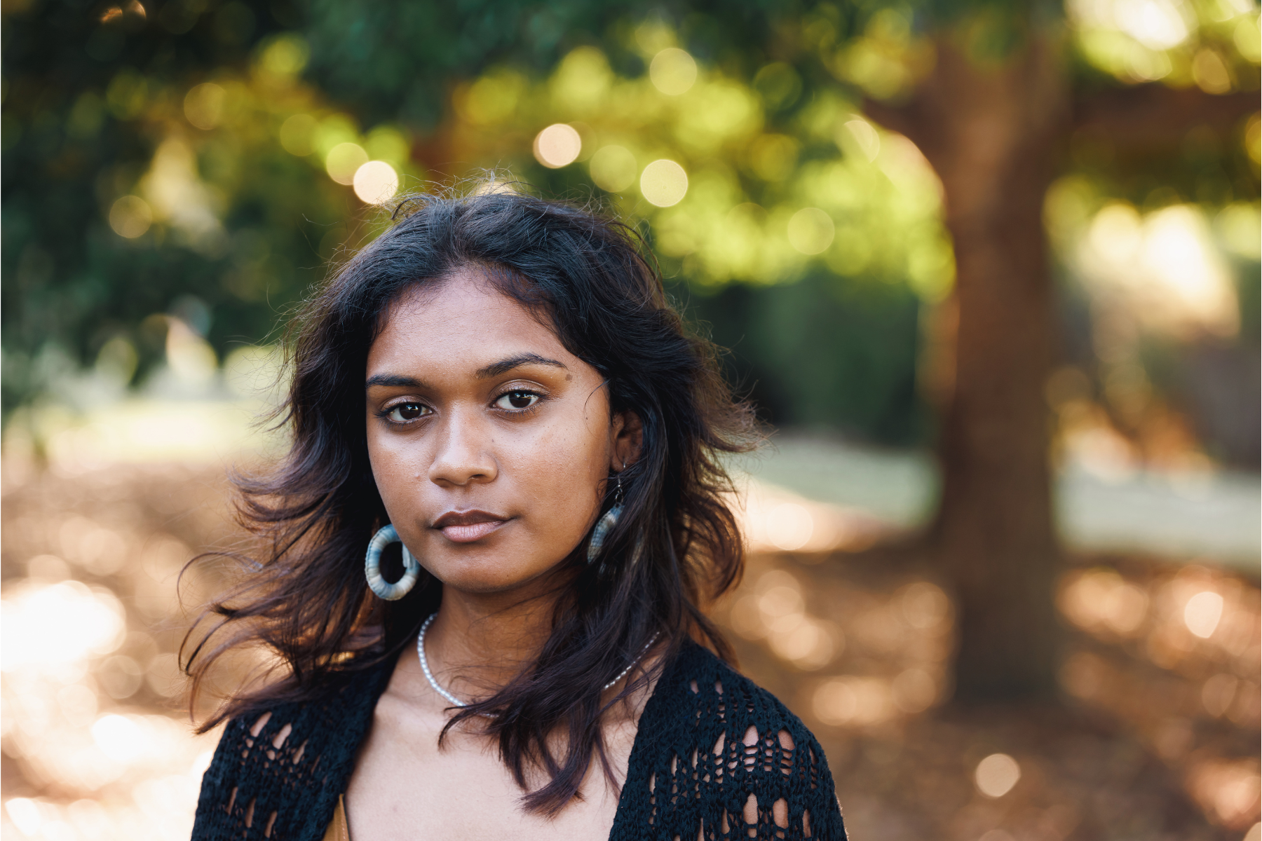 Young Indigenous Australian woman standing in a park