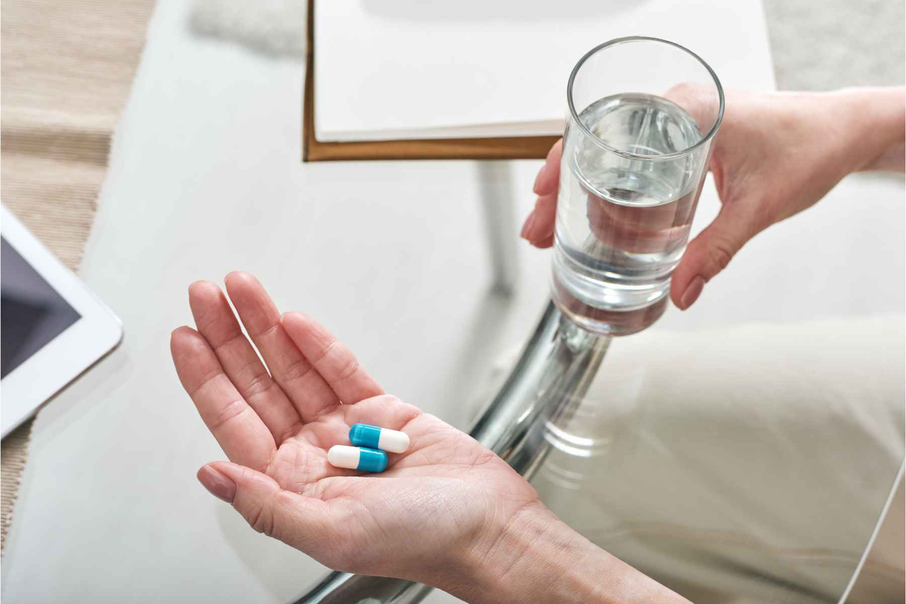 DVA participant taking scheduled medication with a glass of water