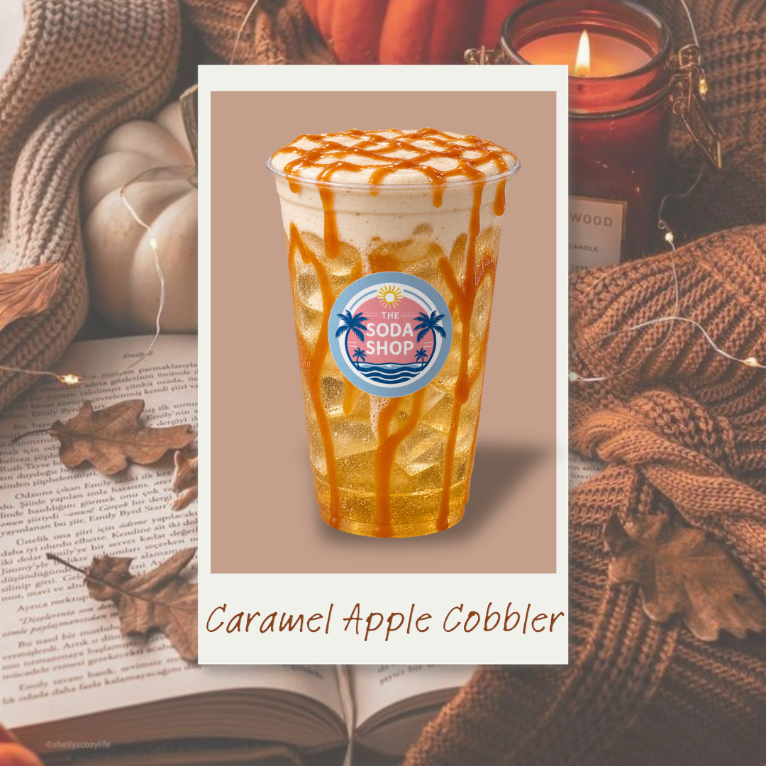 A caramel apple cobbler drink with caramel drizzle, ice, and foam, branded with The Soda Shop logo, over a background with a cozy scene including a candle, a knitted blanket, and autumn leaves.