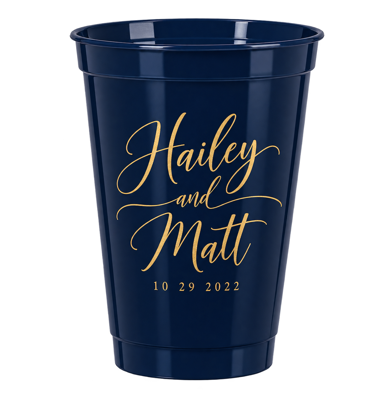 A navy blue tumbler with gold cursive text that reads 'Hailey and Matt,' and the date '10 29 2022' beneath it.
