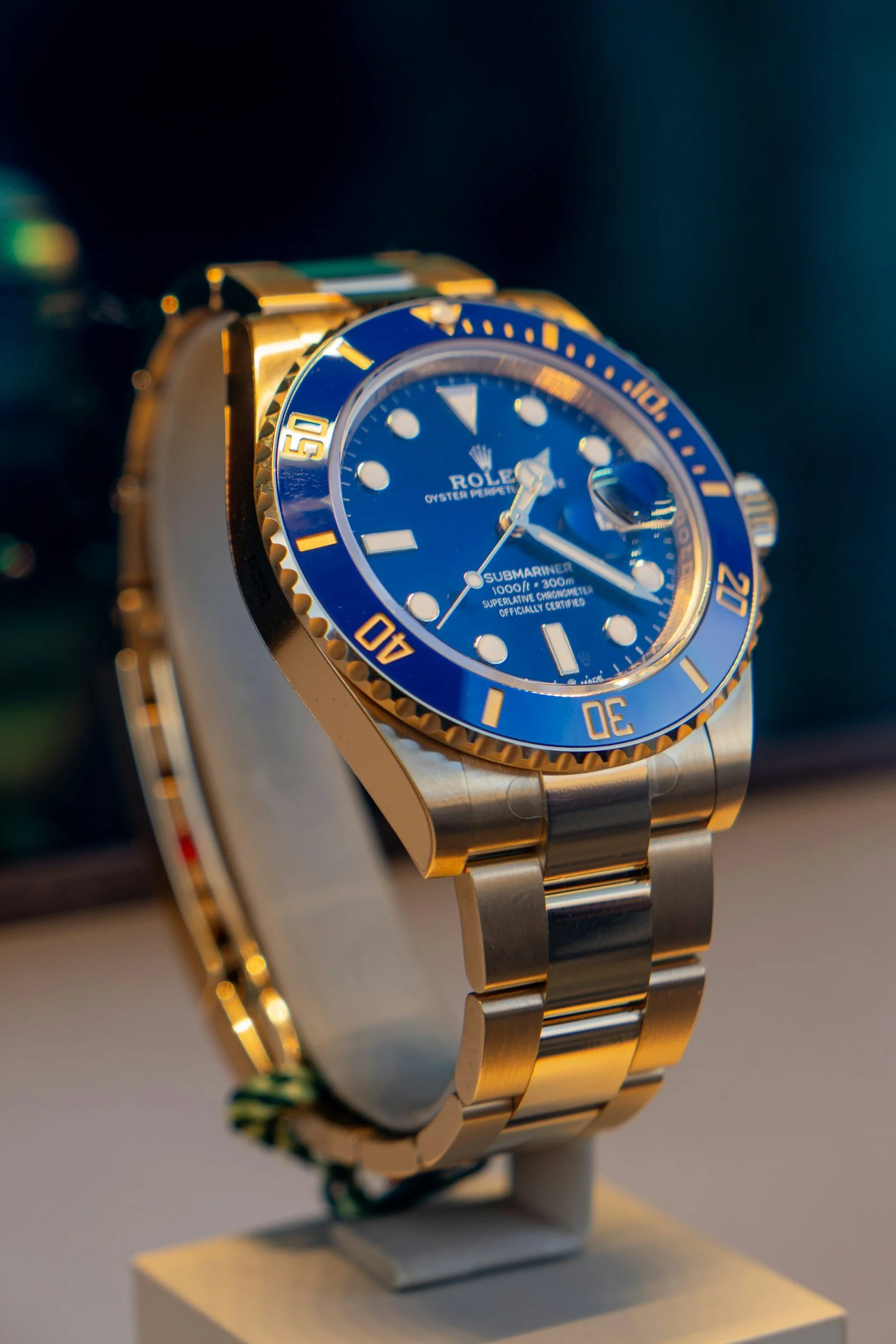 Roteilin Rolex Submariner rannelasissa, jossa sininen kellotaulu ja kultaiset yksityiskohdat.